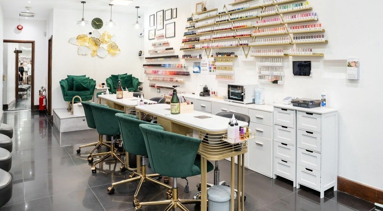 Stylish interior of Nails By Annie Marylebone, London, England, GB featuring cozy seating and nail polish displays.