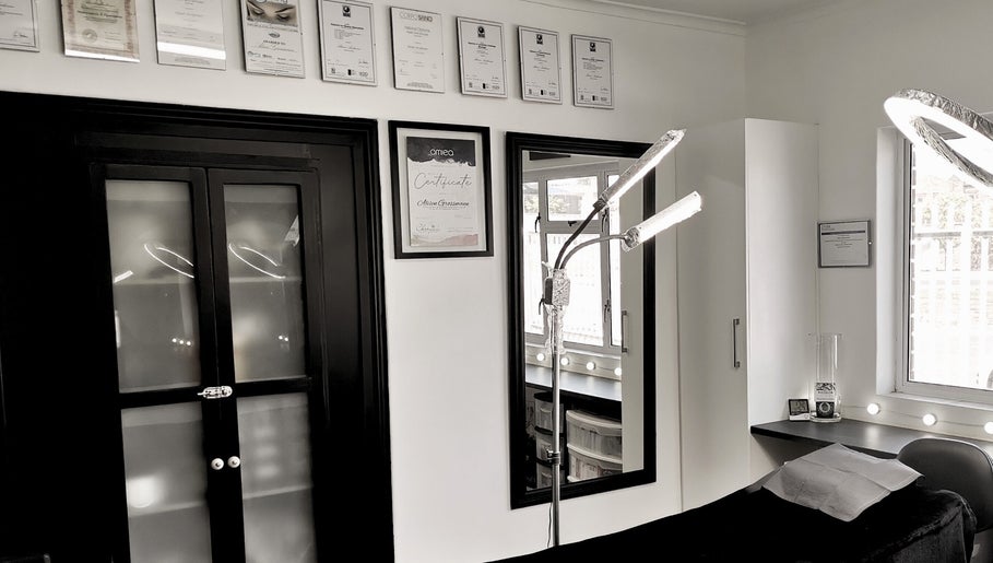 Chic interior of Beauty Evolution in Cape Town, Western Cape, ZA with certificates and modern lighting.