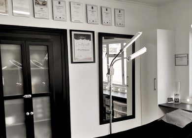 Chic interior of Beauty Evolution in Cape Town, Western Cape, ZA with certificates and modern lighting.