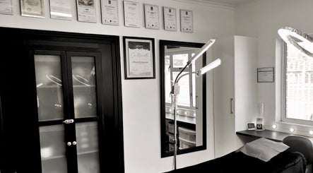 Chic interior of Beauty Evolution in Cape Town, Western Cape, ZA with certificates and modern lighting.