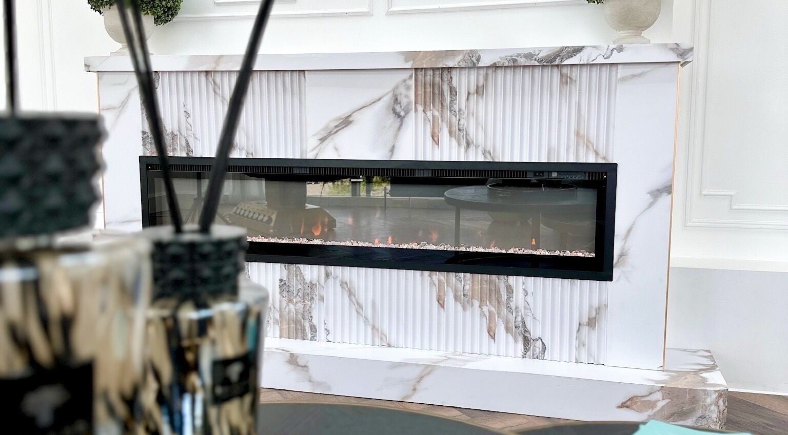 Elegant marble fireplace at Georgie’s Aesthetics Milton Keynes, Milton Keynes, England, GB.