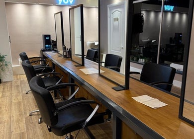 Chic salon interior at Studio 21 in Eckington, England, GB with modern chairs and mirrors.