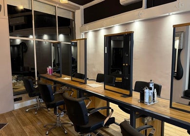Elegant hair styling chairs and mirrors at Studio 21 in Eckington, England, GB, offering a serene design.