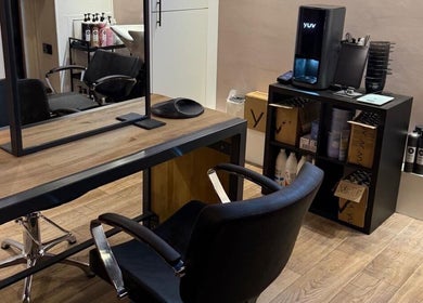 Modern styling station at Studio 21, Eckington, England, GB with sleek chairs and professional products.
