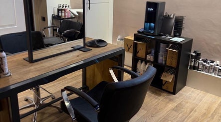 Modern styling station at Studio 21, Eckington, England, GB with sleek chairs and professional products.
