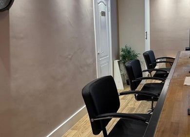 Elegant interior of Studio 21 in Eckington, England, GB featuring sleek black chairs and wooden decor.