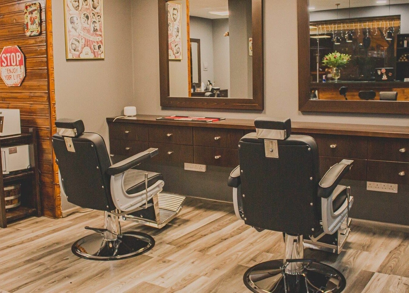 Chic interior of Mancave Barbershop in Limassol, CY featuring modern styling chairs and mirrors.