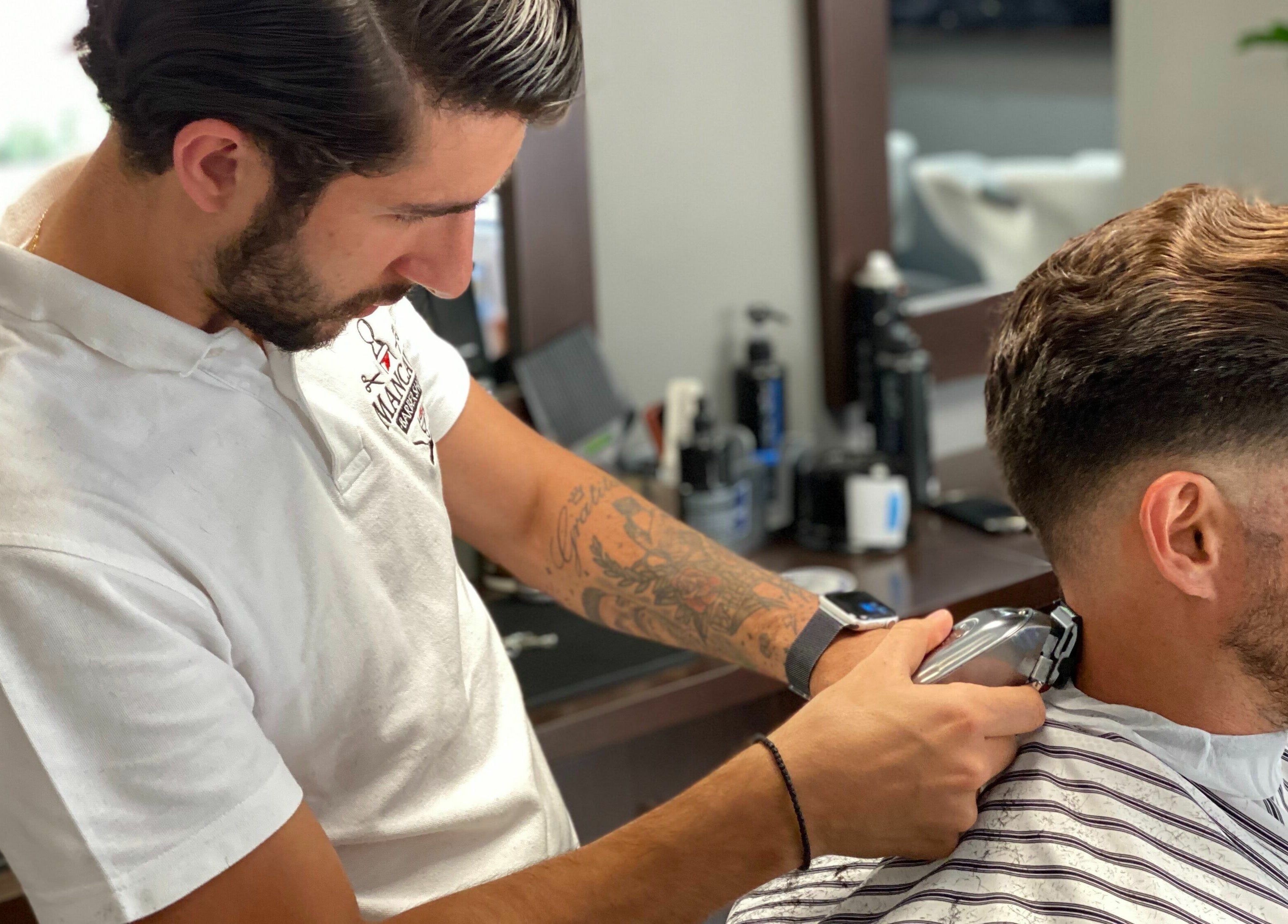 Barber expertly trims client's hair at Mancave Barbershop, Limassol, Limassol, CY.