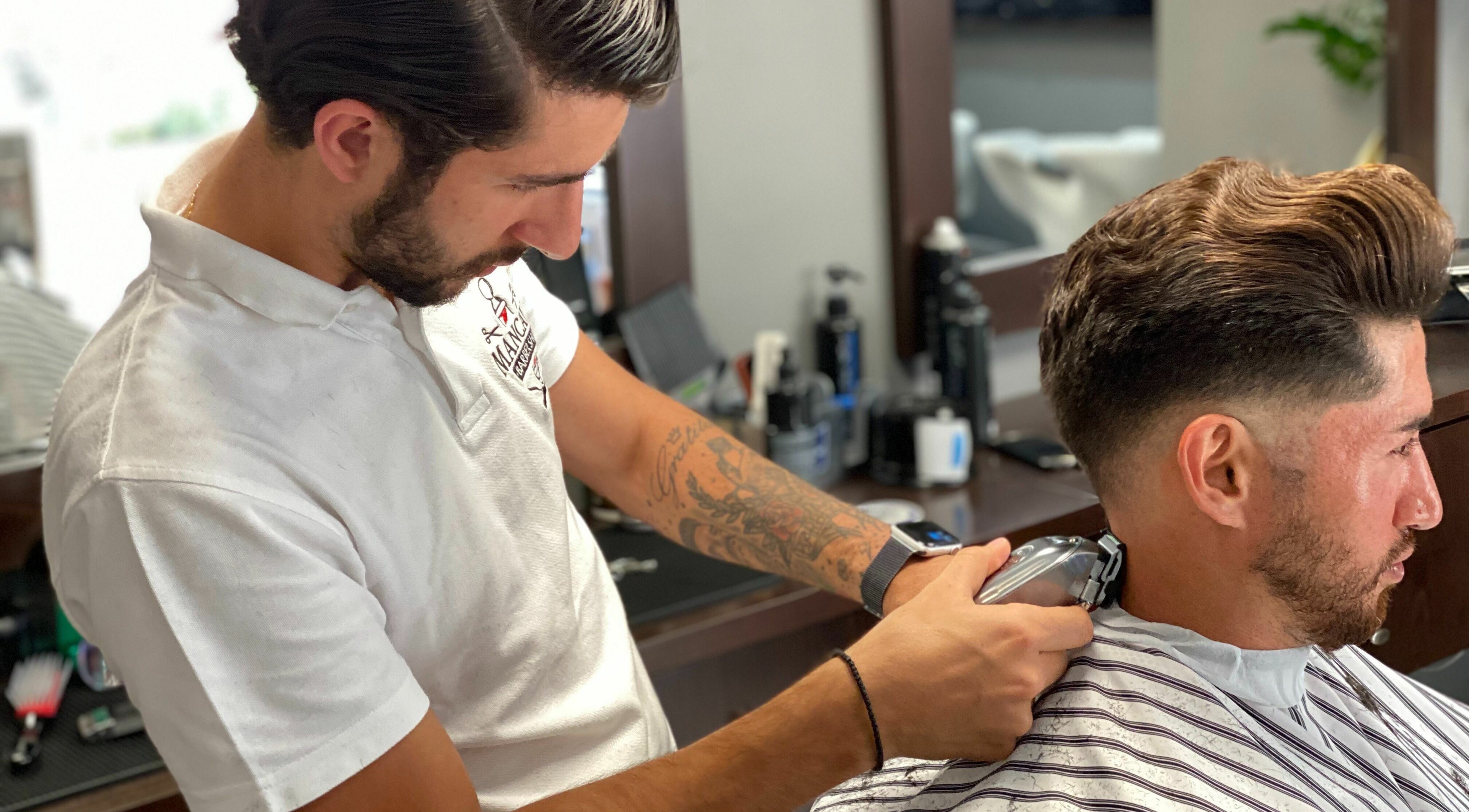 Barber expertly trims client's hair at Mancave Barbershop, Limassol, Limassol, CY.