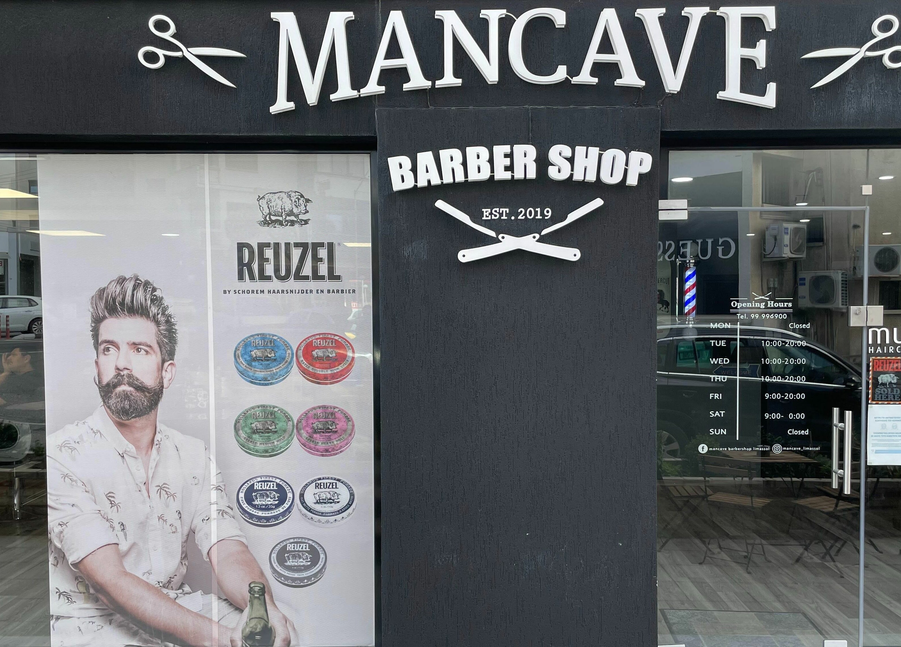Entrance of Mancave Barbershop in Limassol, CY showcasing chic decor and professional ambiance.