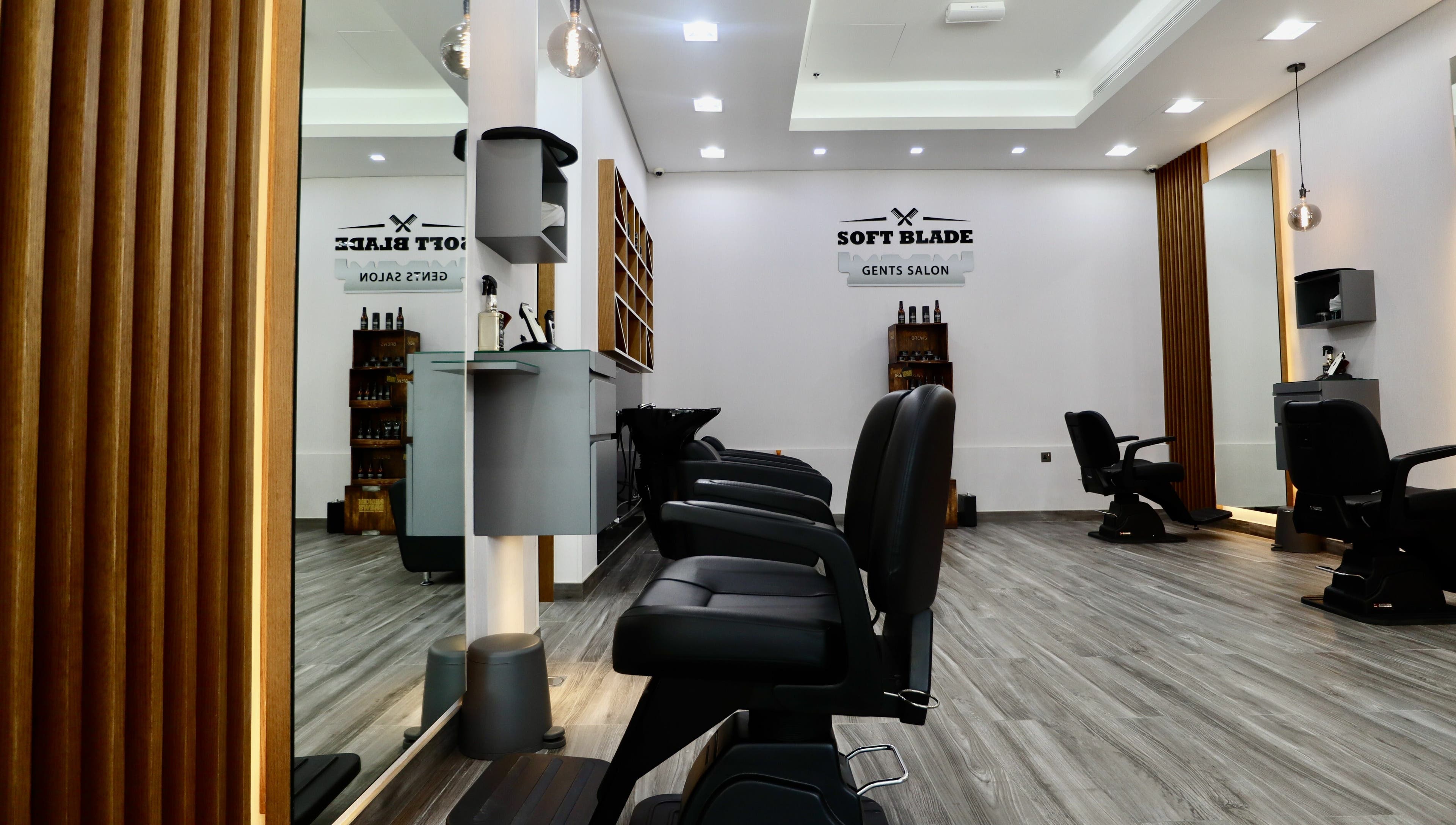 Interior of Soft Blade Gents Salon, Dubai, Dubai, AE, featuring sleek barber chairs and modern decor.