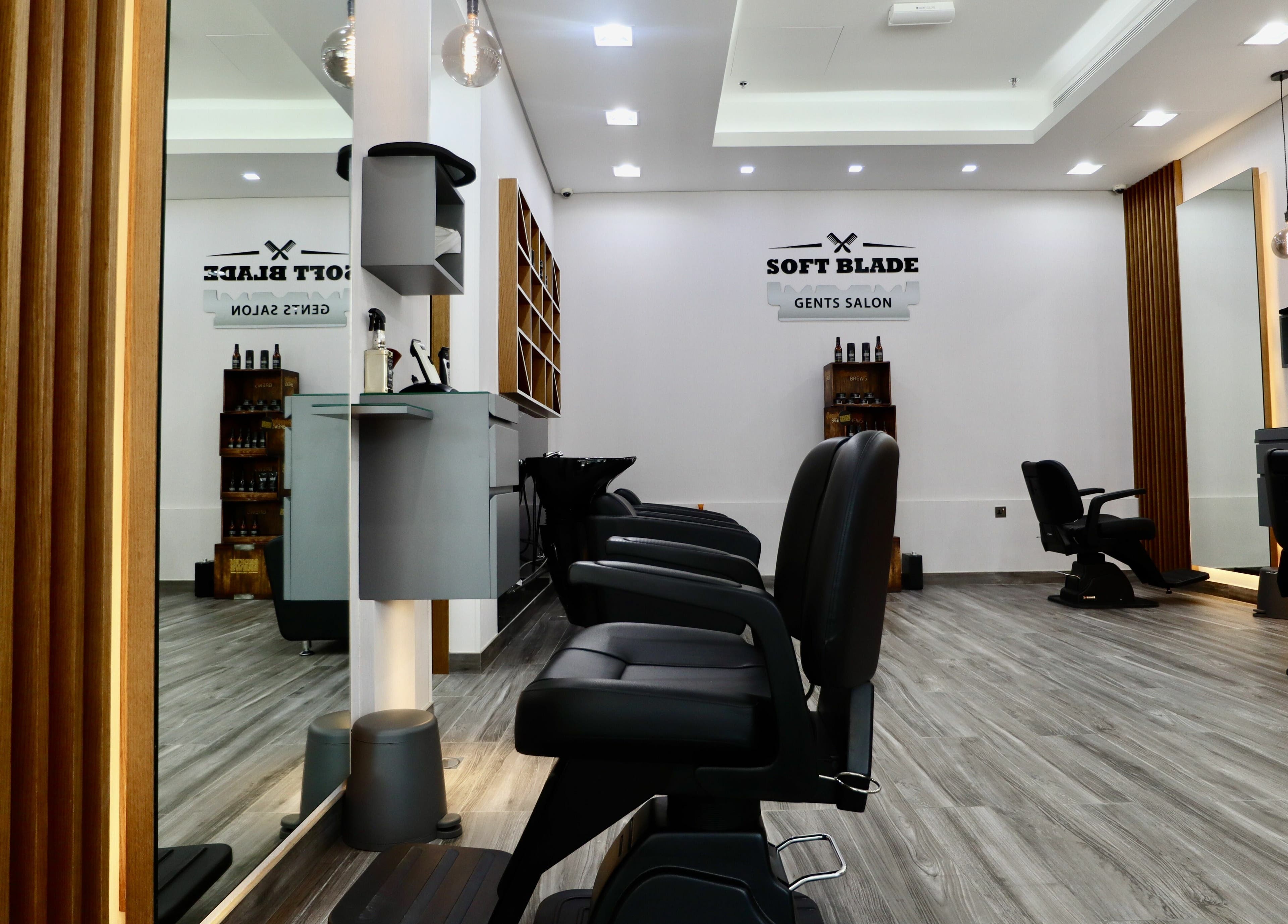 Interior of Soft Blade Gents Salon, Dubai, Dubai, AE, featuring sleek barber chairs and modern decor.