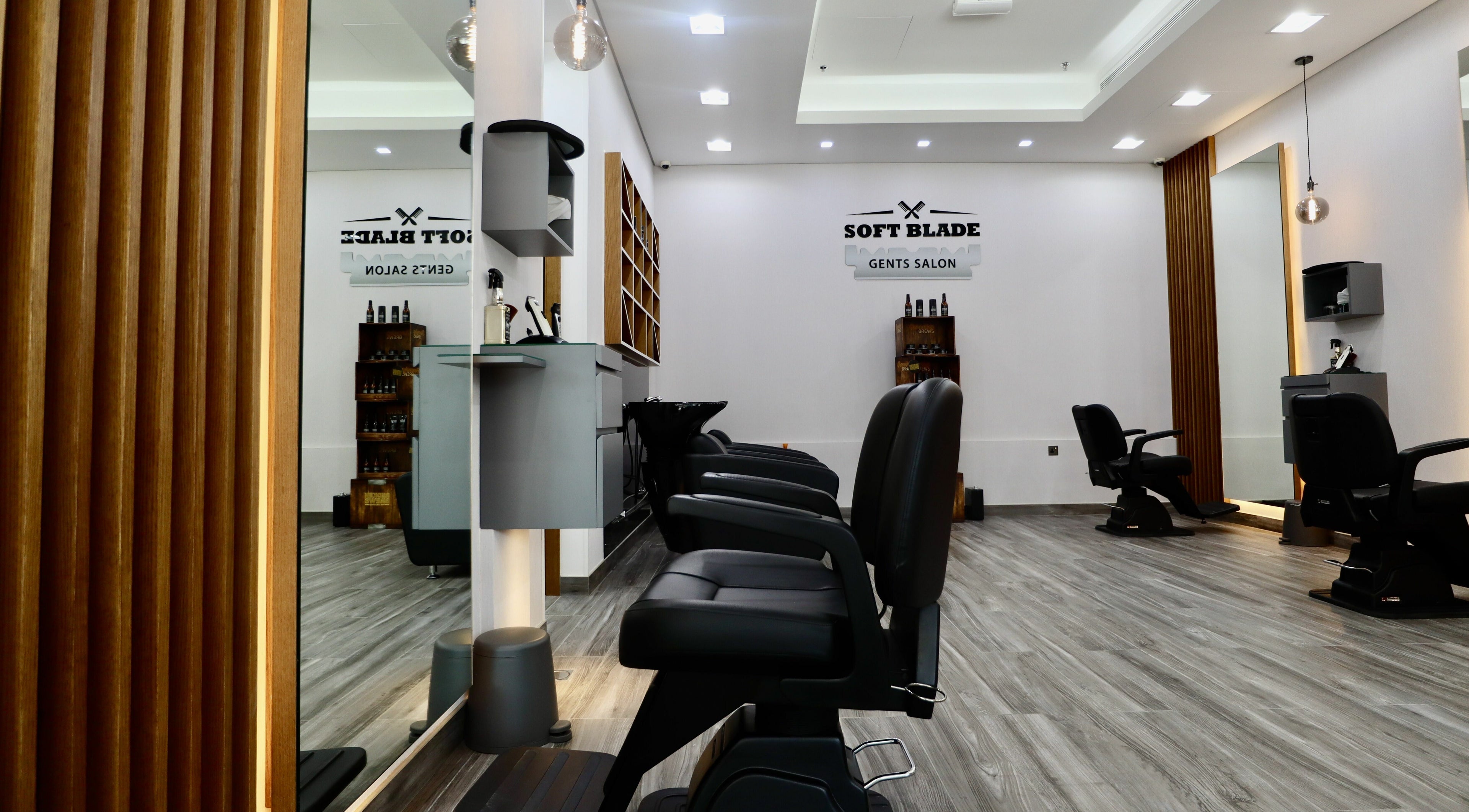 Interior of Soft Blade Gents Salon, Dubai, Dubai, AE, featuring sleek barber chairs and modern decor.