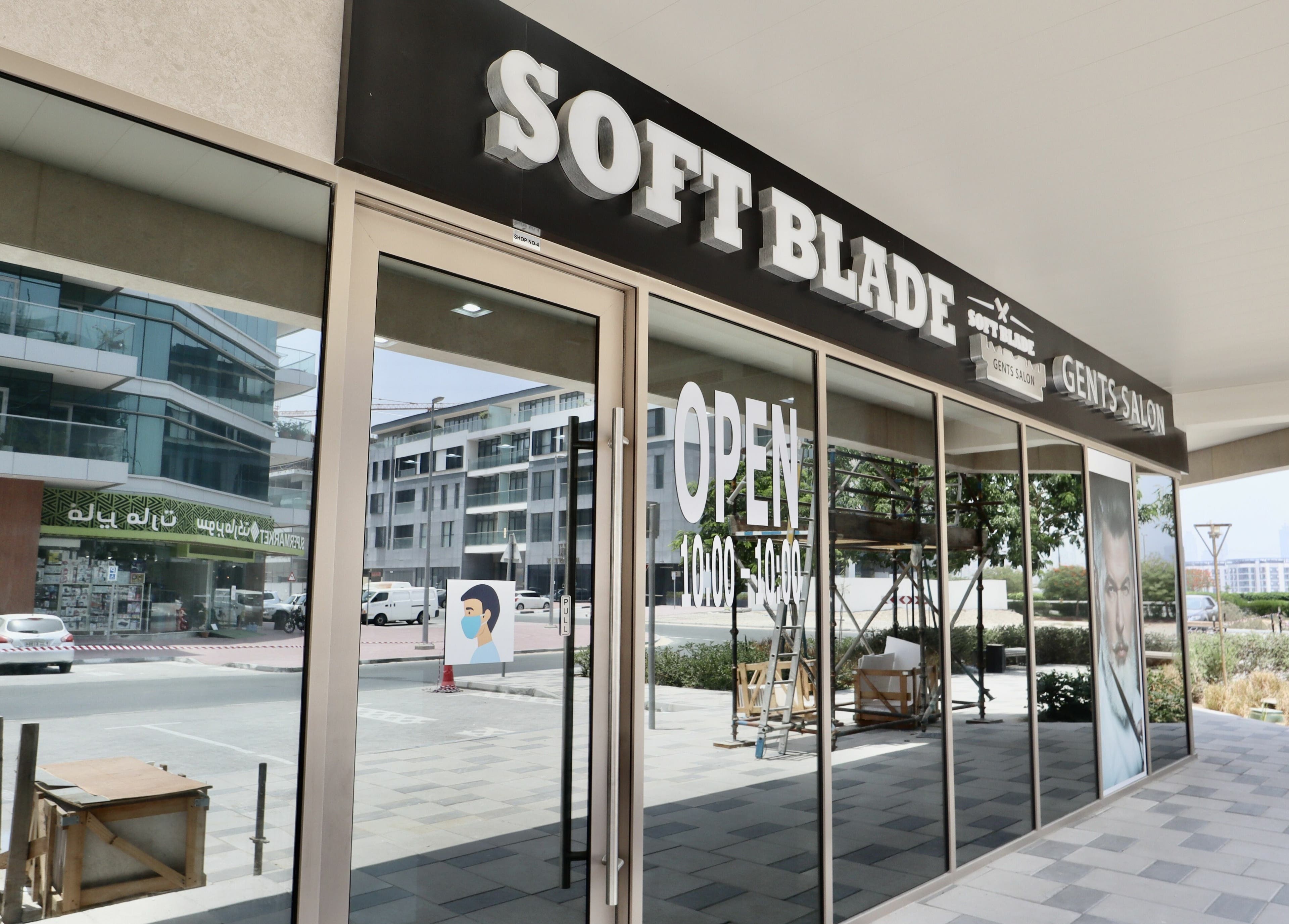 Exterior of Soft Blade Gents Salon in Dubai, Dubai, AE with large windows and open signage.