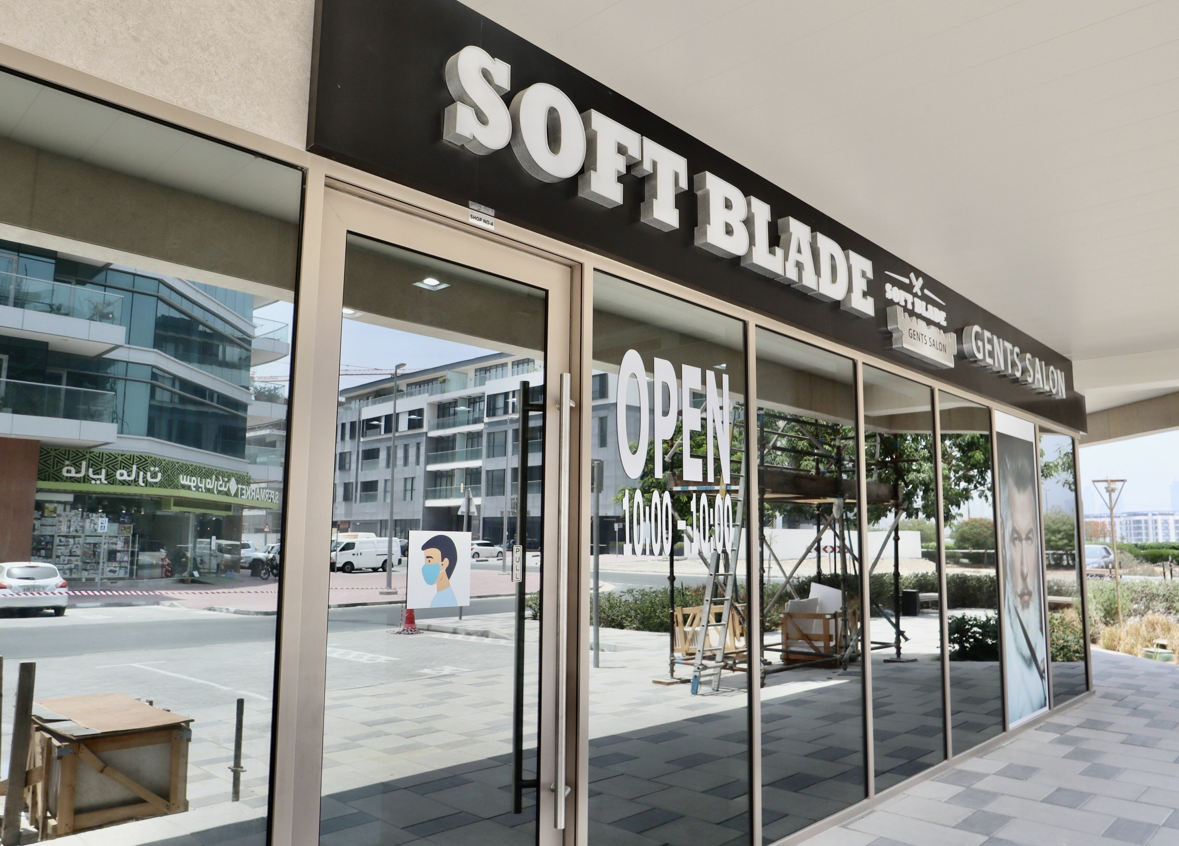 Exterior of Soft Blade Gents Salon in Dubai, Dubai, AE with large windows and open signage.