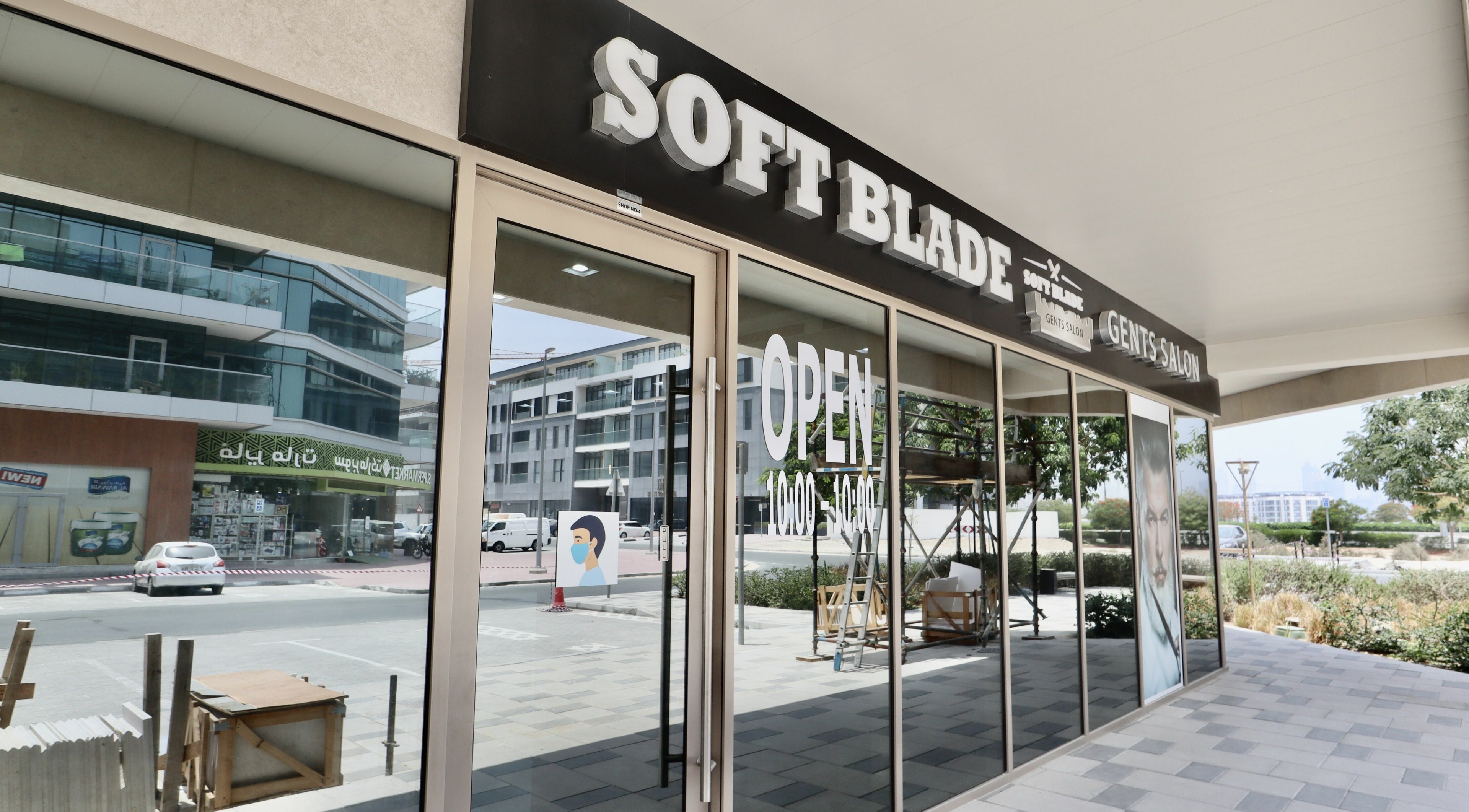 Exterior of Soft Blade Gents Salon in Dubai, Dubai, AE with large windows and open signage.