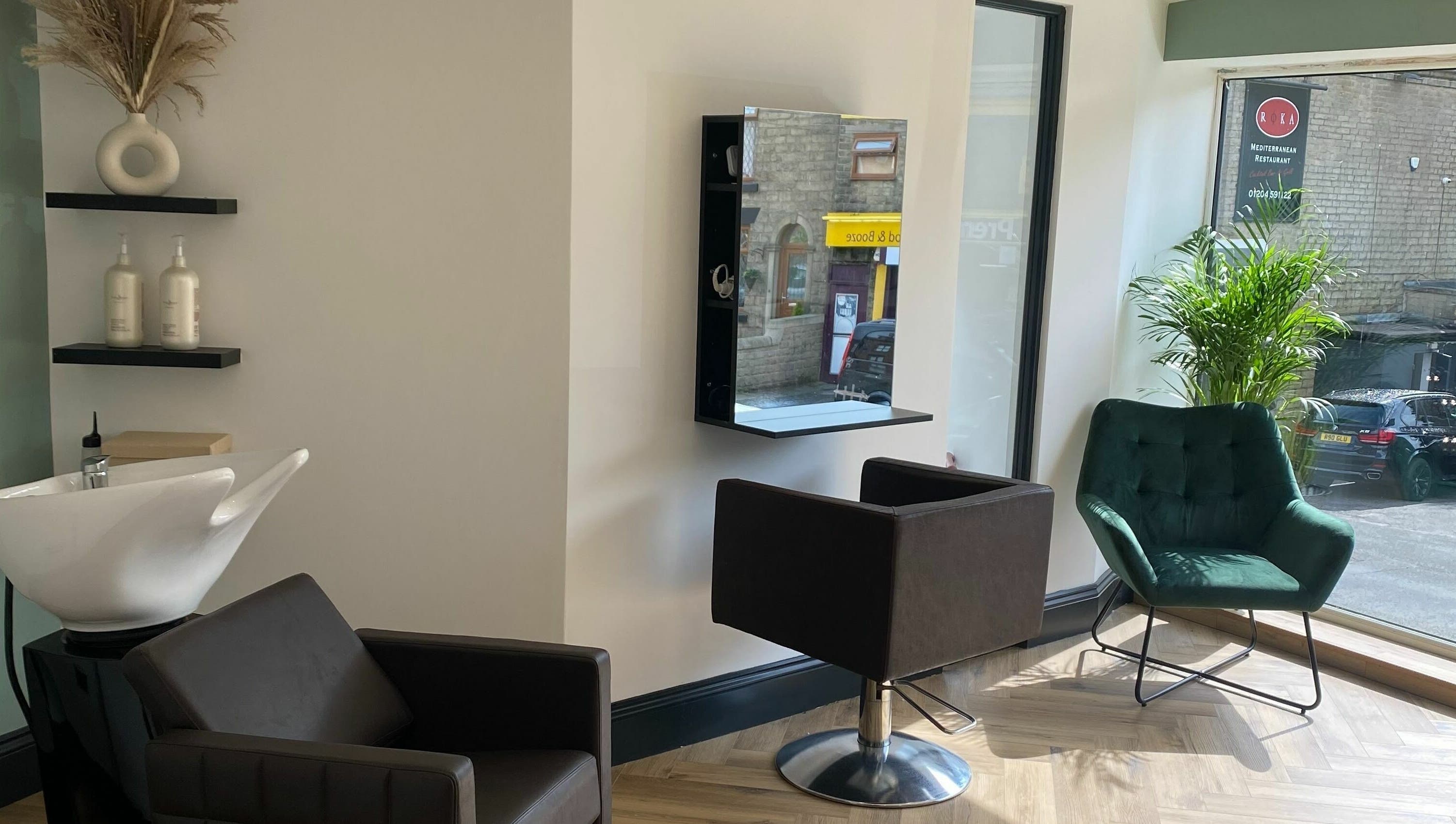 Stylish salon area at Leanne Alexandra in Bolton, England, GB, featuring modern seating and a sleek washing station.