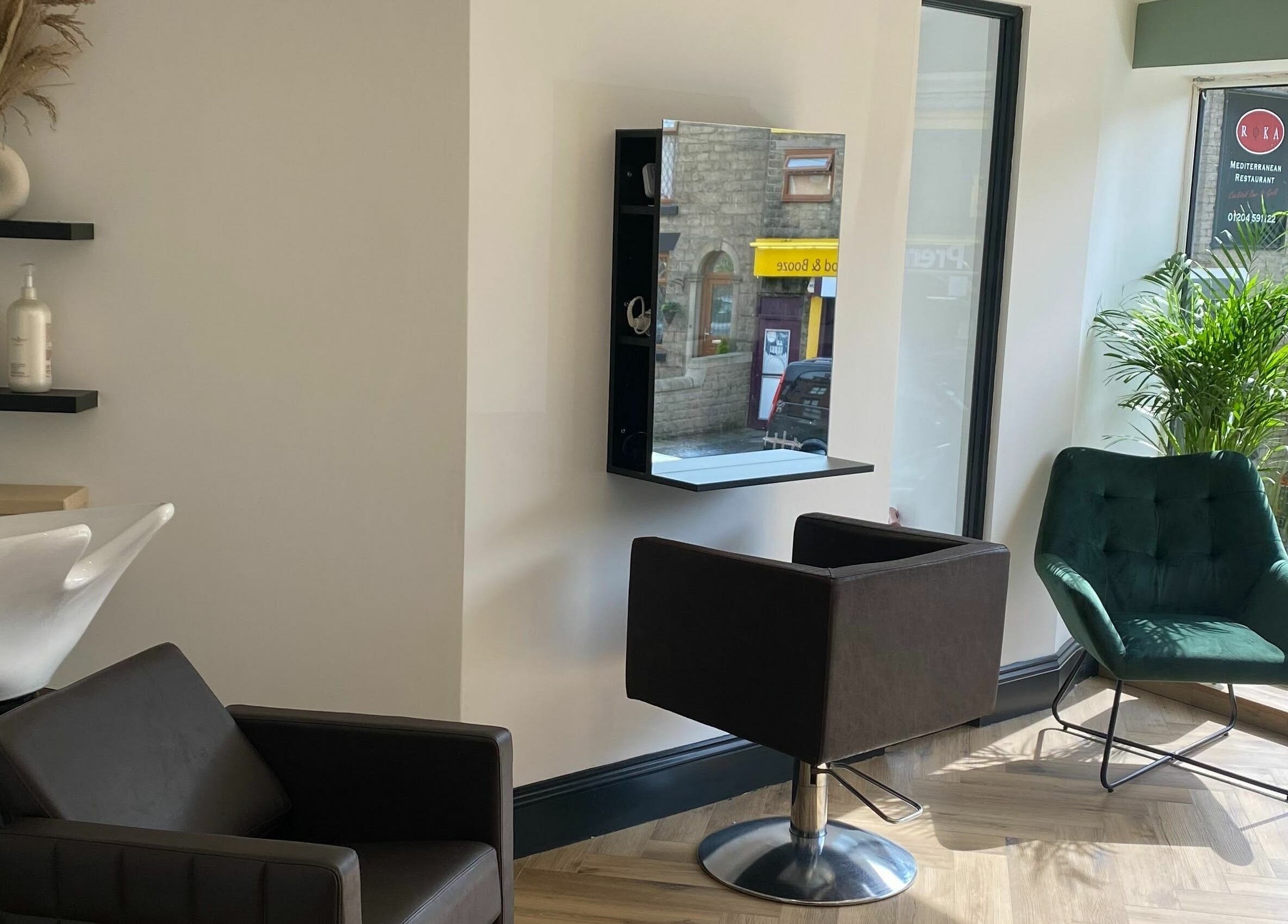 Stylish salon area at Leanne Alexandra in Bolton, England, GB, featuring modern seating and a sleek washing station.