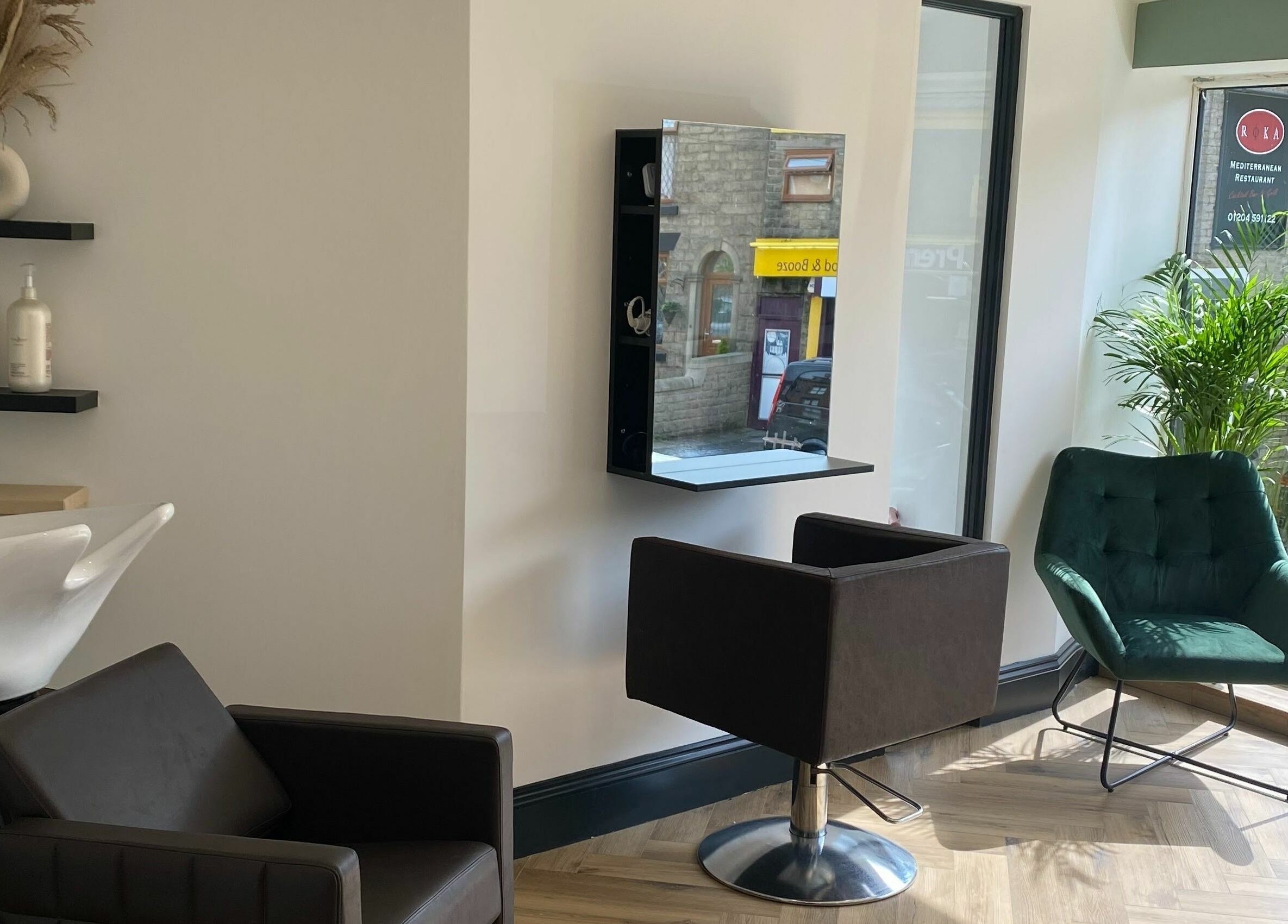 Stylish salon area at Leanne Alexandra in Bolton, England, GB, featuring modern seating and a sleek washing station.