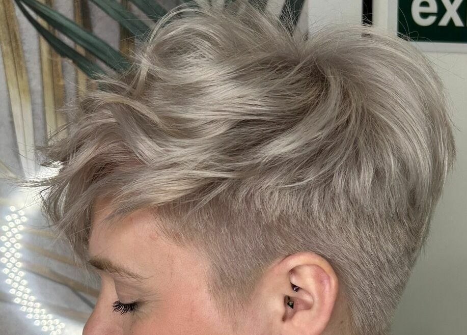 Stylish pixie cut hairstyle at Leanne Alexandra, Bolton, England, GB with soft blonde tones.