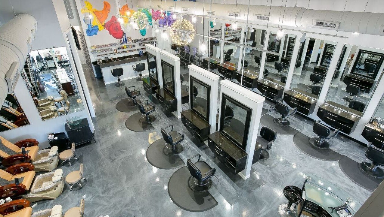 View of stylish salon interior at Alka's Glo Studio in Helotes, Texas, US, showcasing modern chairs and mirrors.