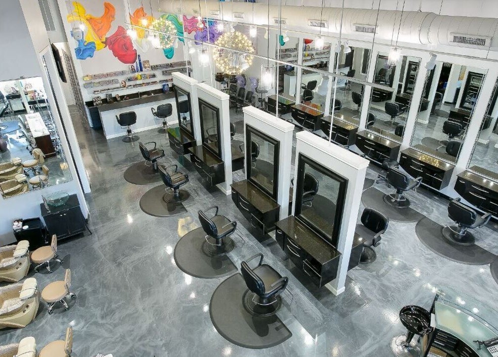 View of stylish salon interior at Alka's Glo Studio in Helotes, Texas, US, showcasing modern chairs and mirrors.