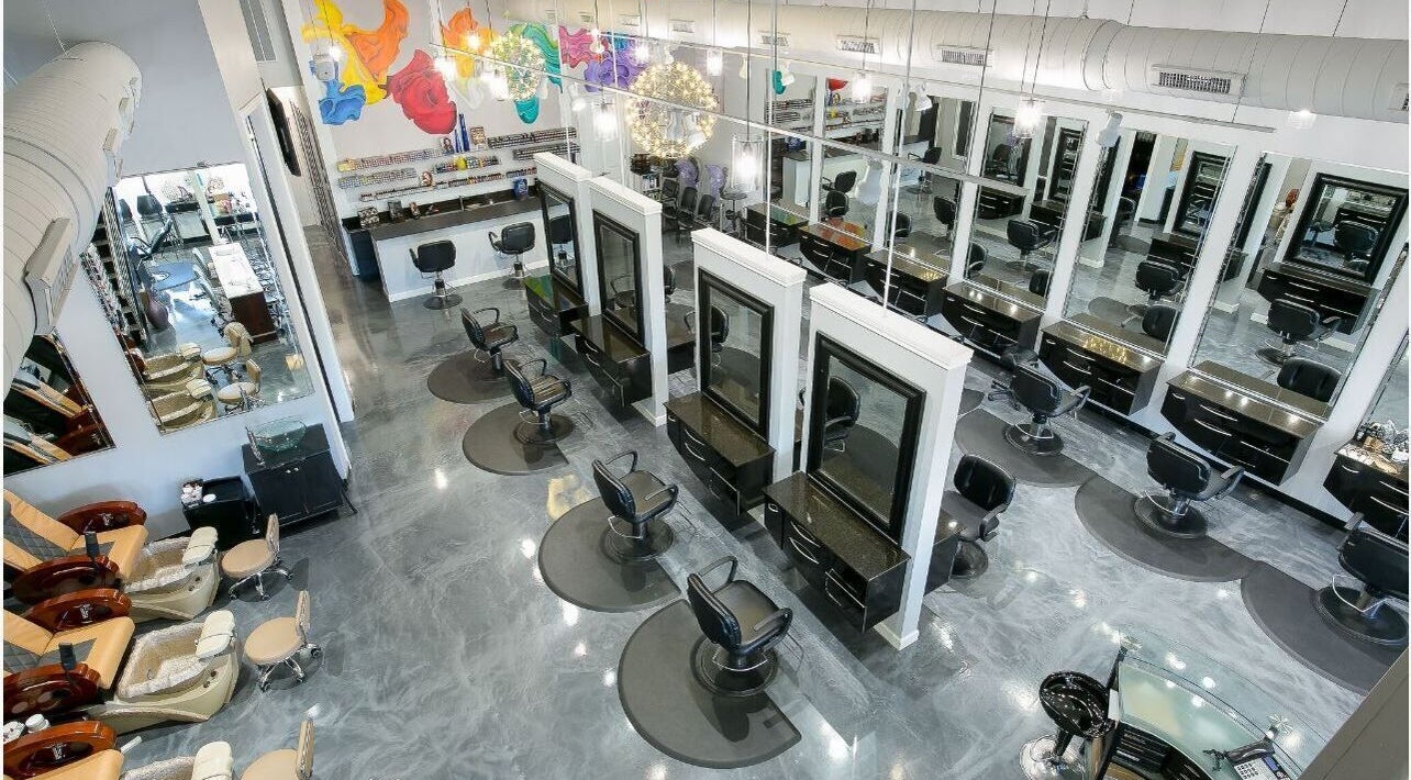 View of stylish salon interior at Alka's Glo Studio in Helotes, Texas, US, showcasing modern chairs and mirrors.