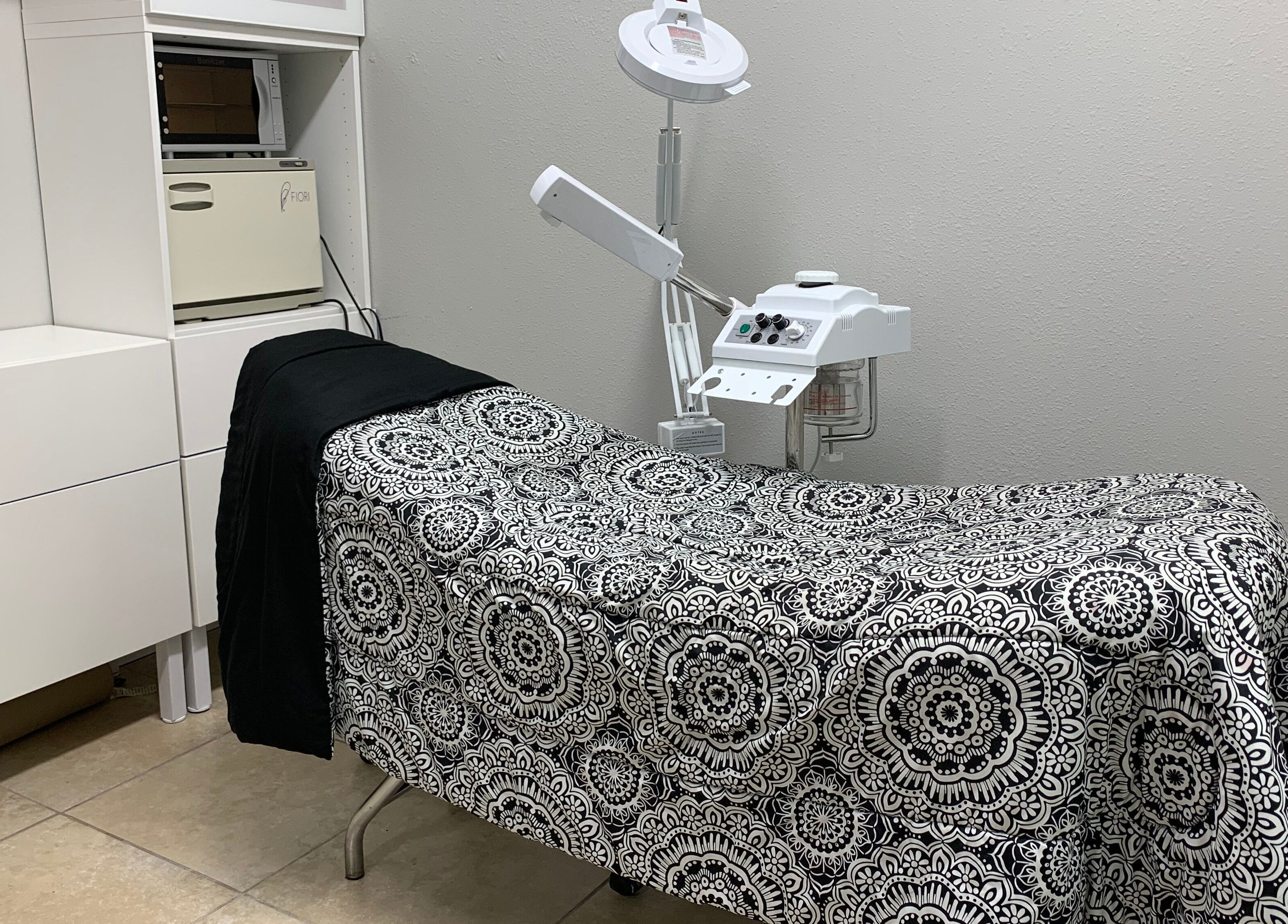 Treatment room at Alka's Glo Studio, Helotes, Texas, US with elegant decor and modern equipment.