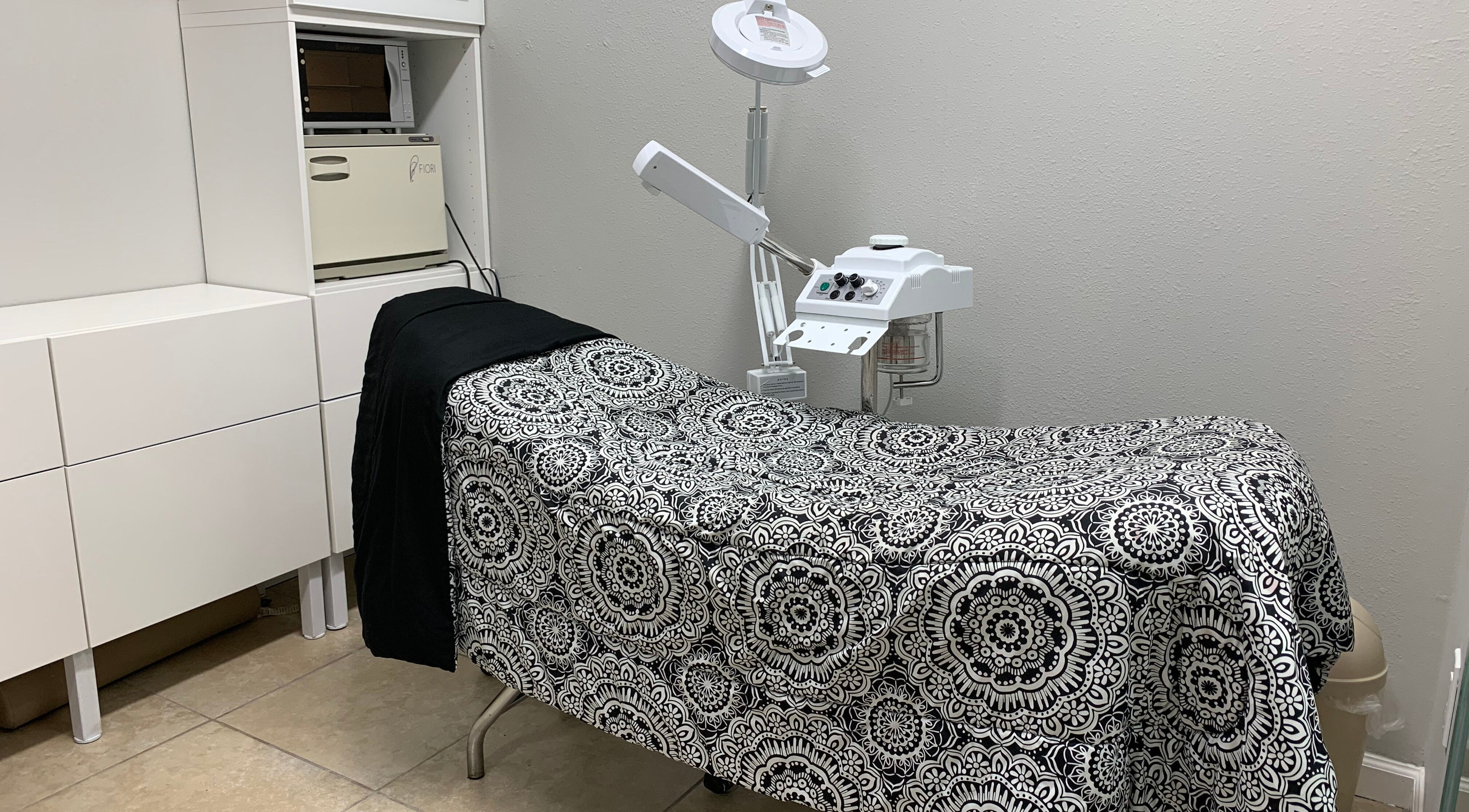 Treatment room at Alka's Glo Studio, Helotes, Texas, US with elegant decor and modern equipment.