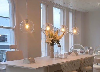 Chic interior of The Bella Lounge, Plymouth, England with elegant lighting and plush seating.