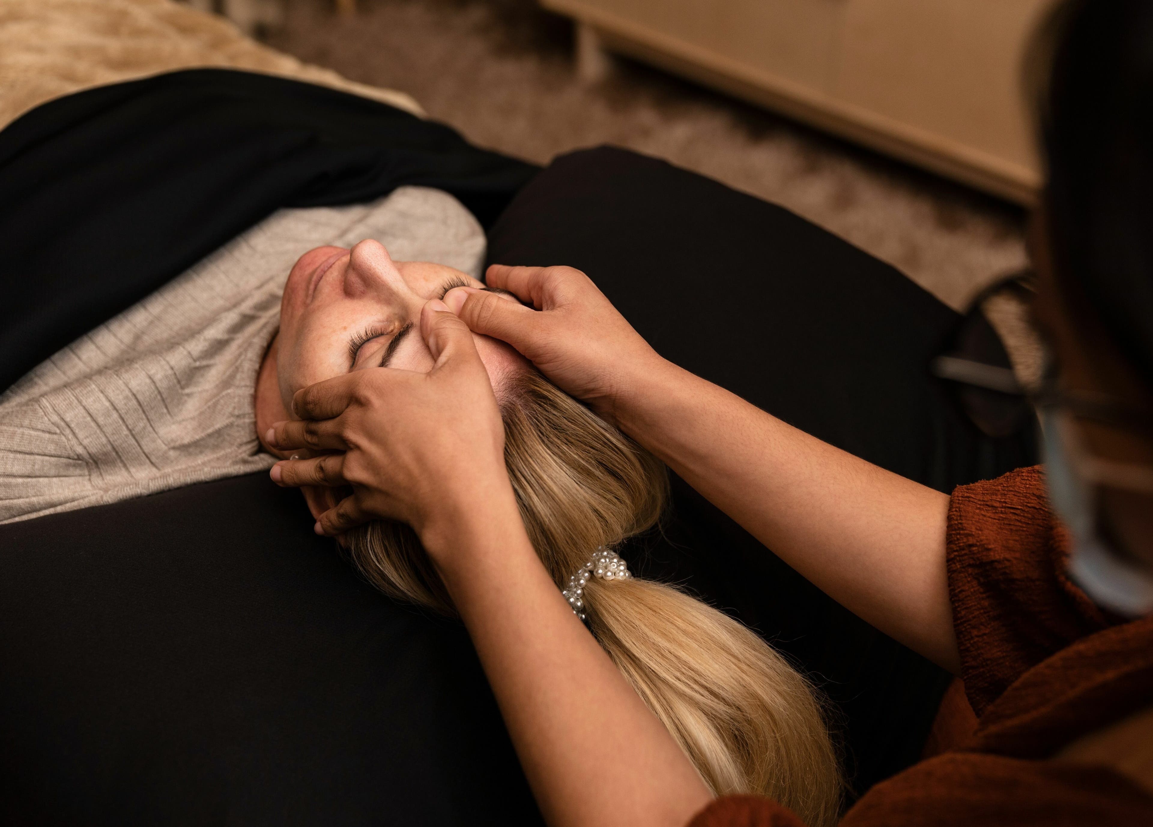 Facial massage at Artisan Skin in Cape Town, Western Cape, ZA. Gentle hands pamper a relaxed client.