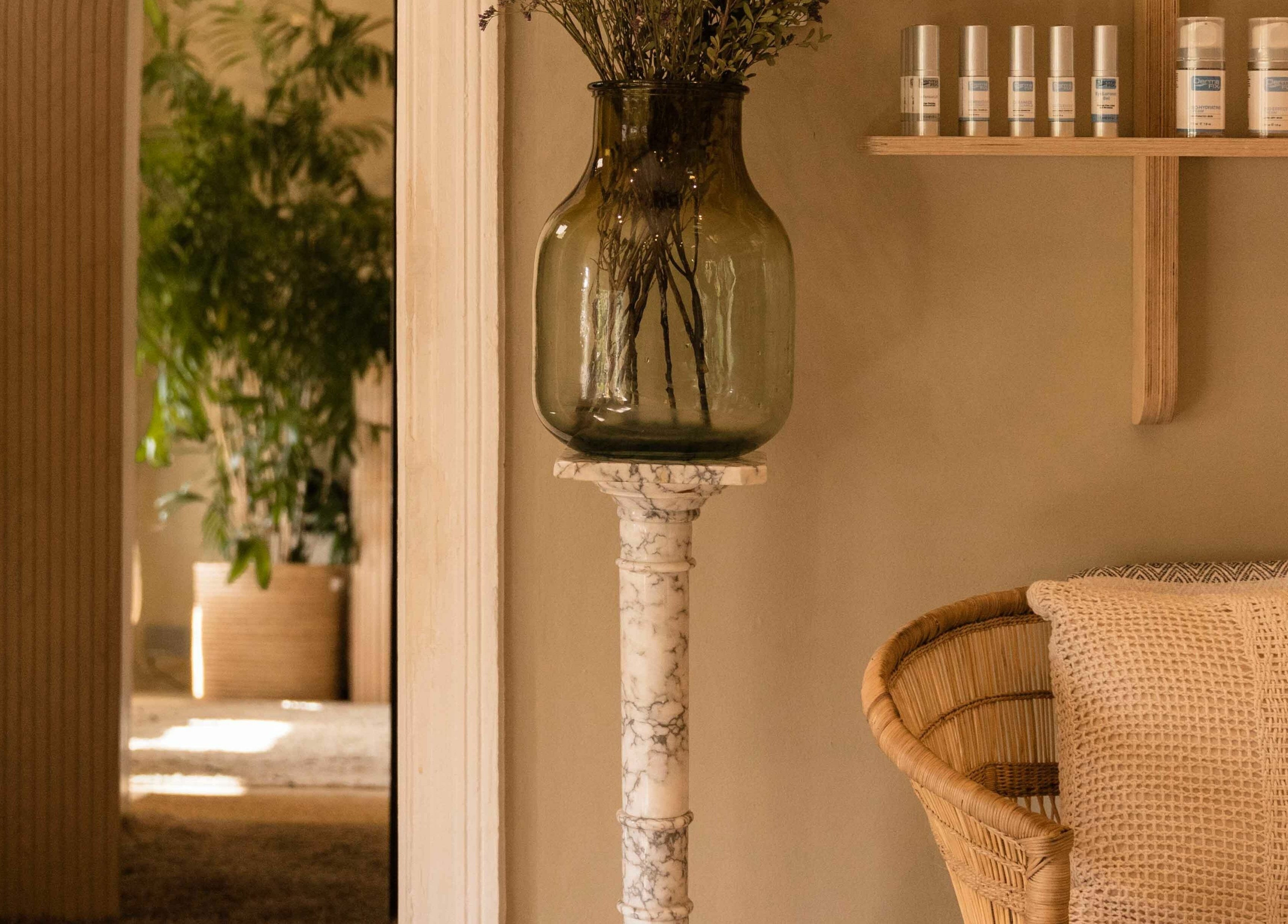 Artisan Skin's calming corner with a wicker chair and decor in Cape Town, Western Cape, ZA.