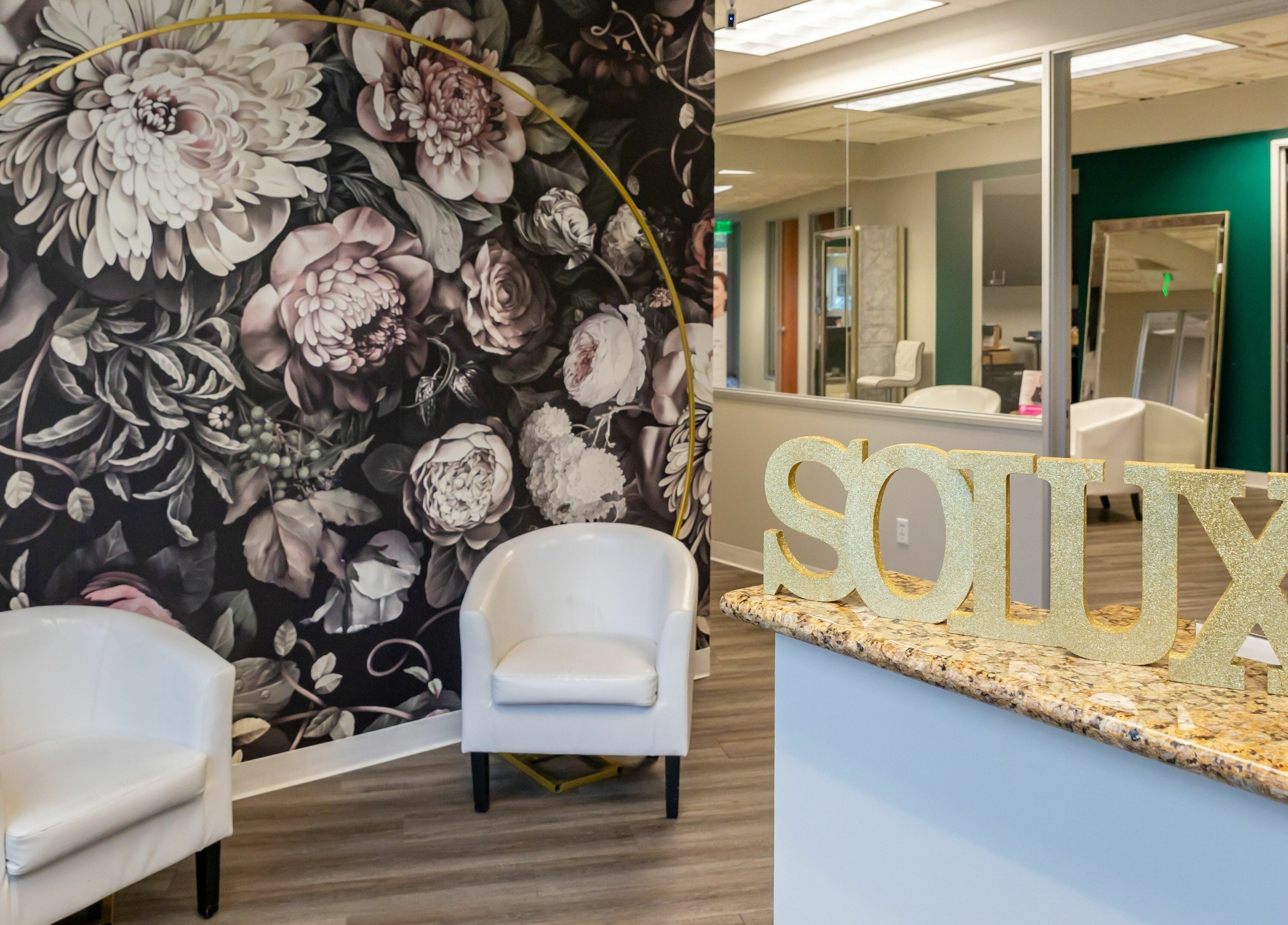 Interior of So Luxe Salon in Rancho Cucamonga, California, featuring floral decor and modern seating.