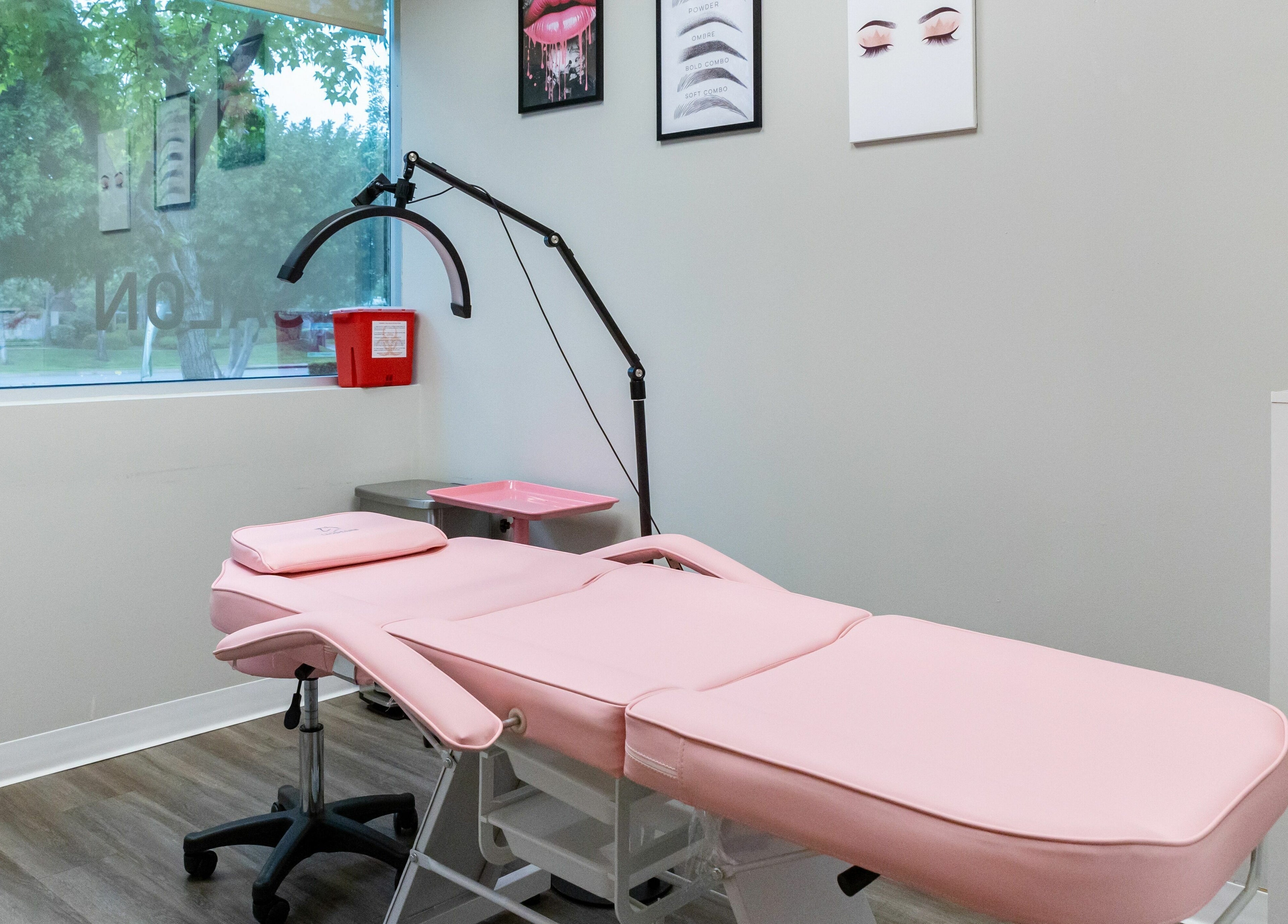 So Luxe Med Spa treatment room in Rancho Cucamonga, California, US with pink massage bed and modern decor.