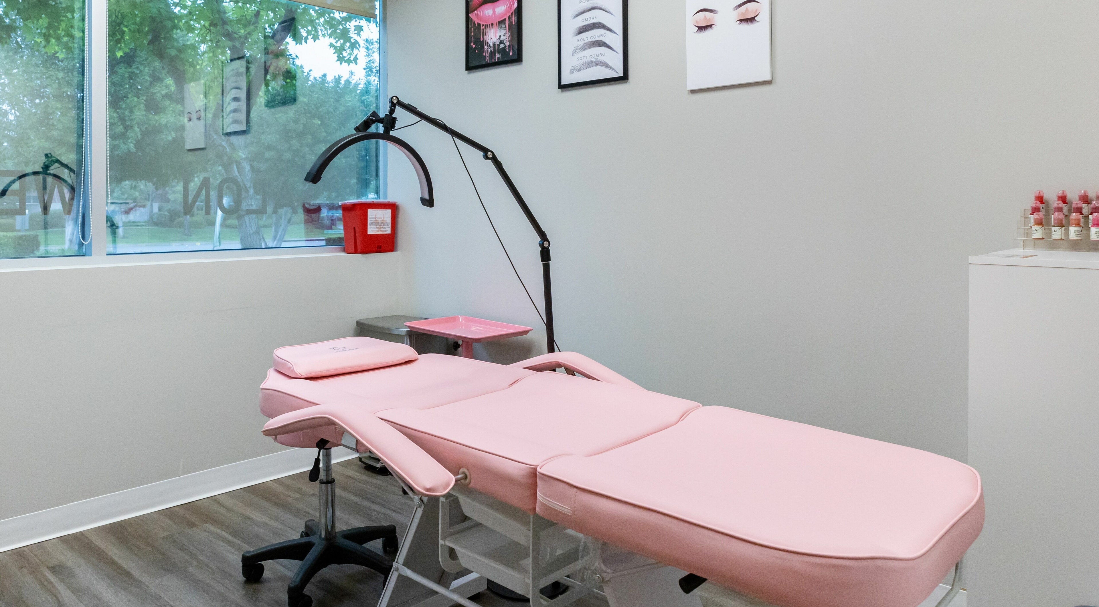 So Luxe Med Spa treatment room in Rancho Cucamonga, California, US with pink massage bed and modern decor.