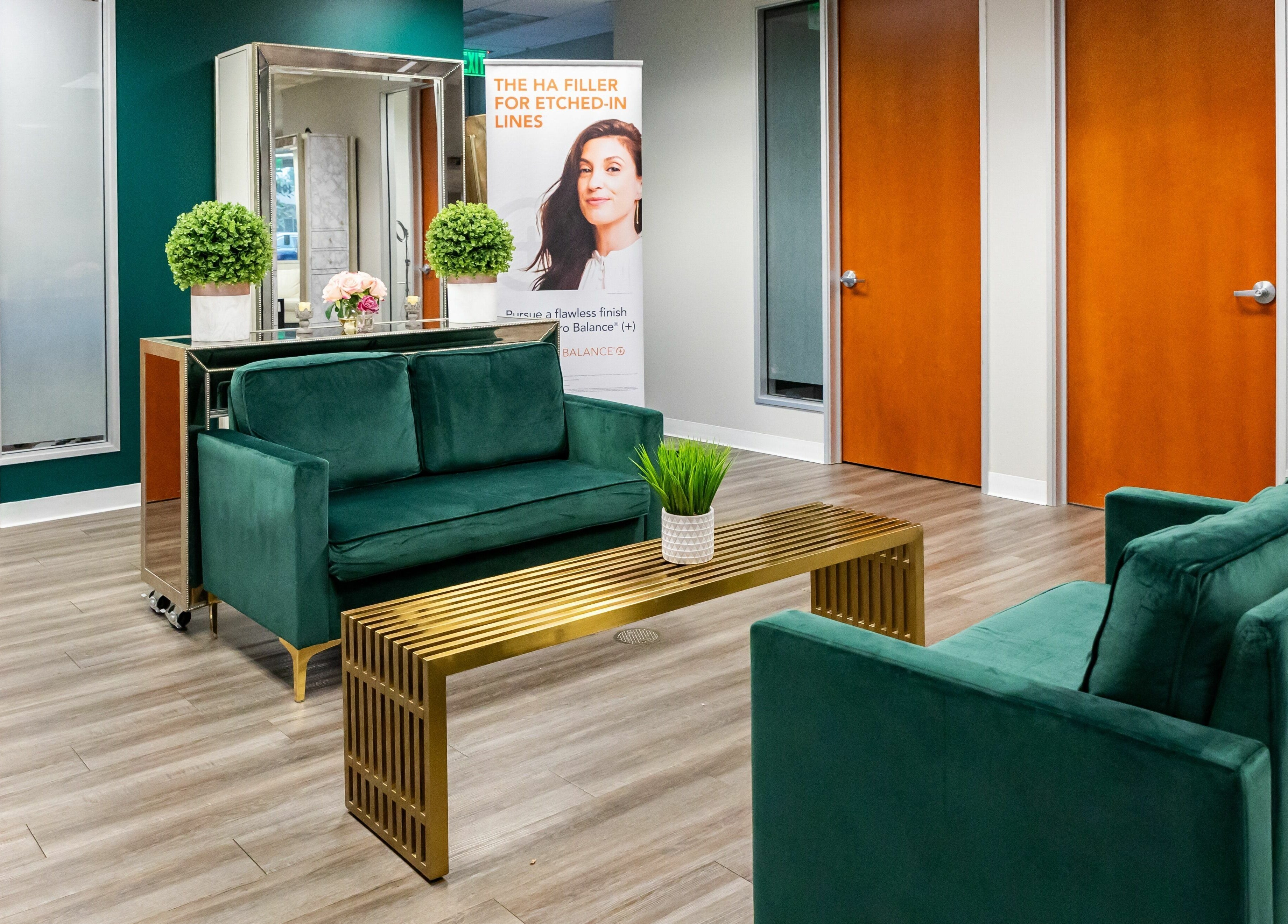 Elegant waiting area at So Luxe Med Spa, Rancho Cucamonga, California, US, featuring chic green sofas and modern decor.