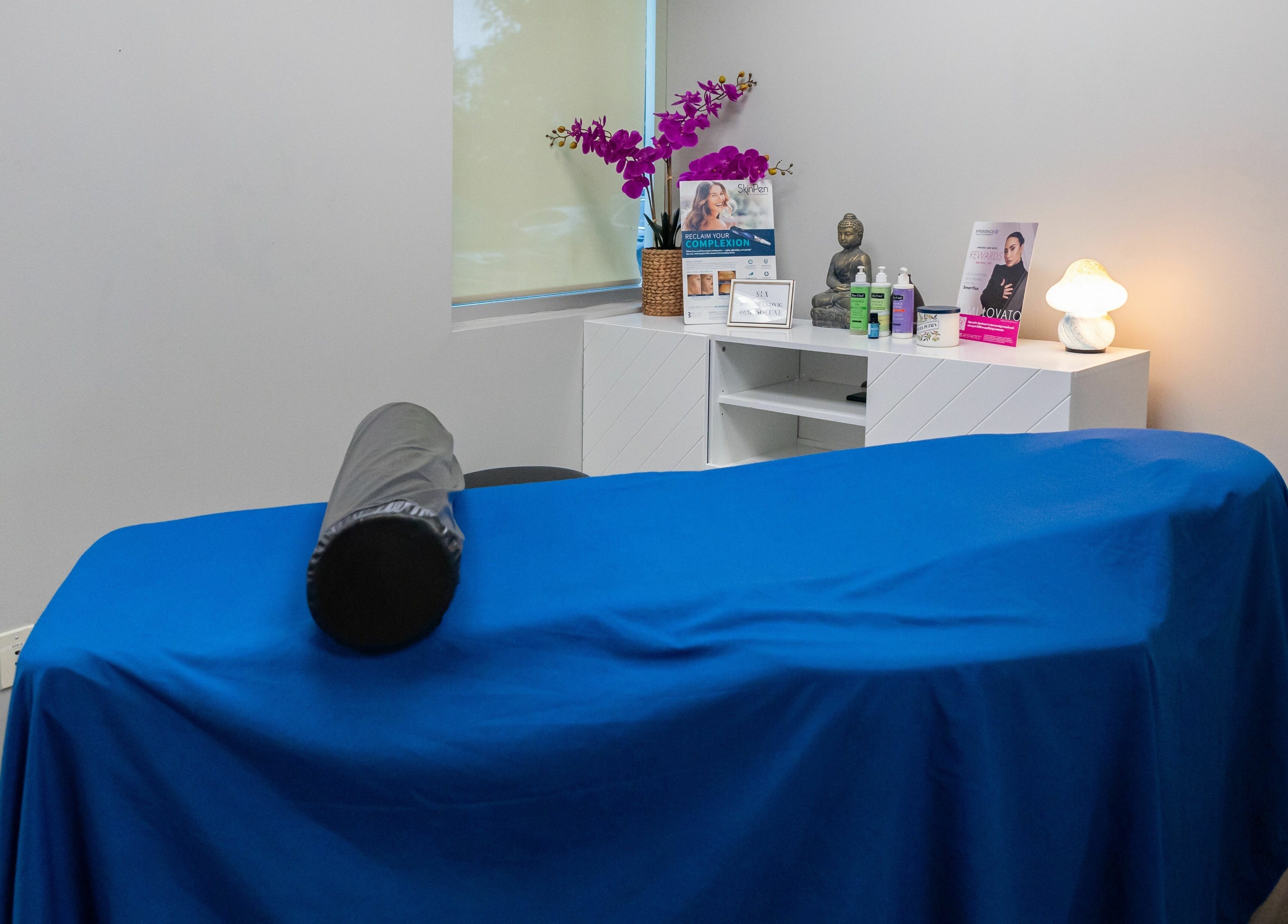 Peaceful massage room at So Luxe Med Spa, Rancho Cucamonga, California, US, with blue covered table.