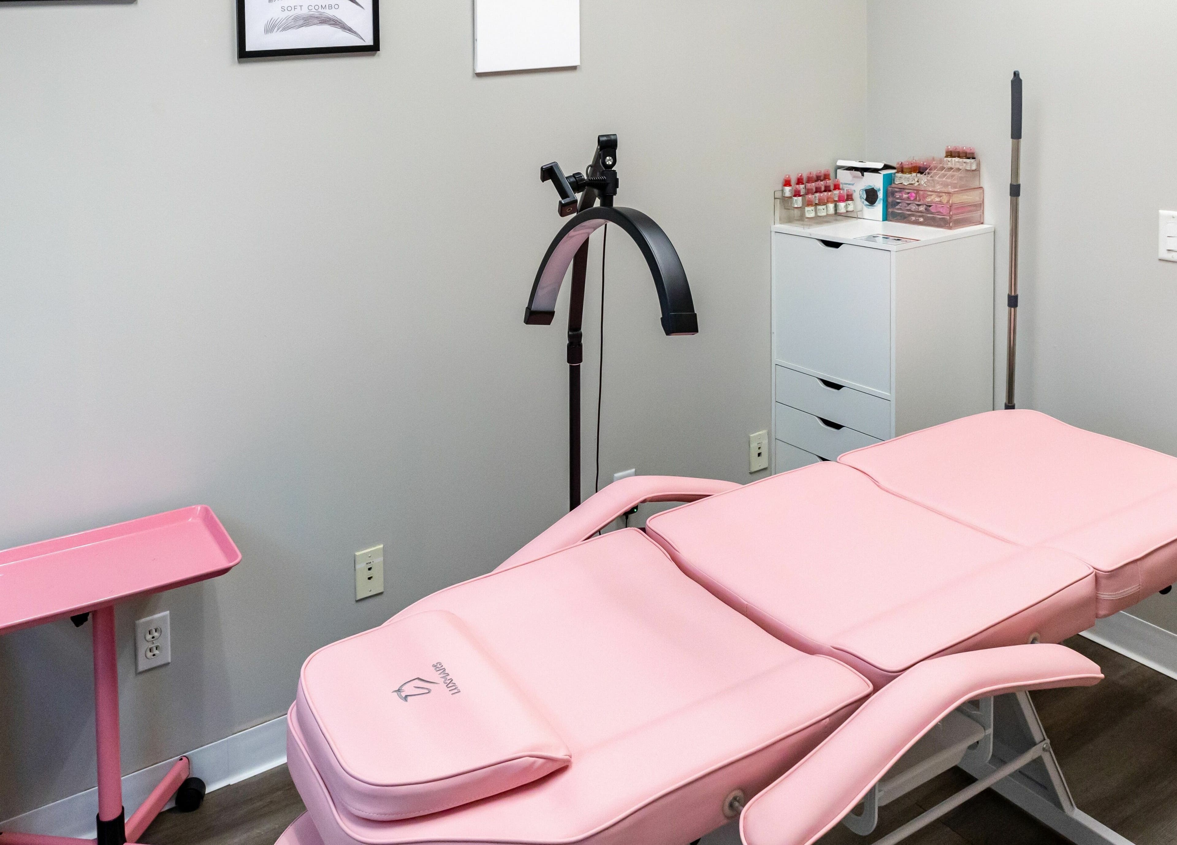 Elegant treatment room at So Luxe Med Spa in Rancho Cucamonga, California, US featuring a pink spa bed.