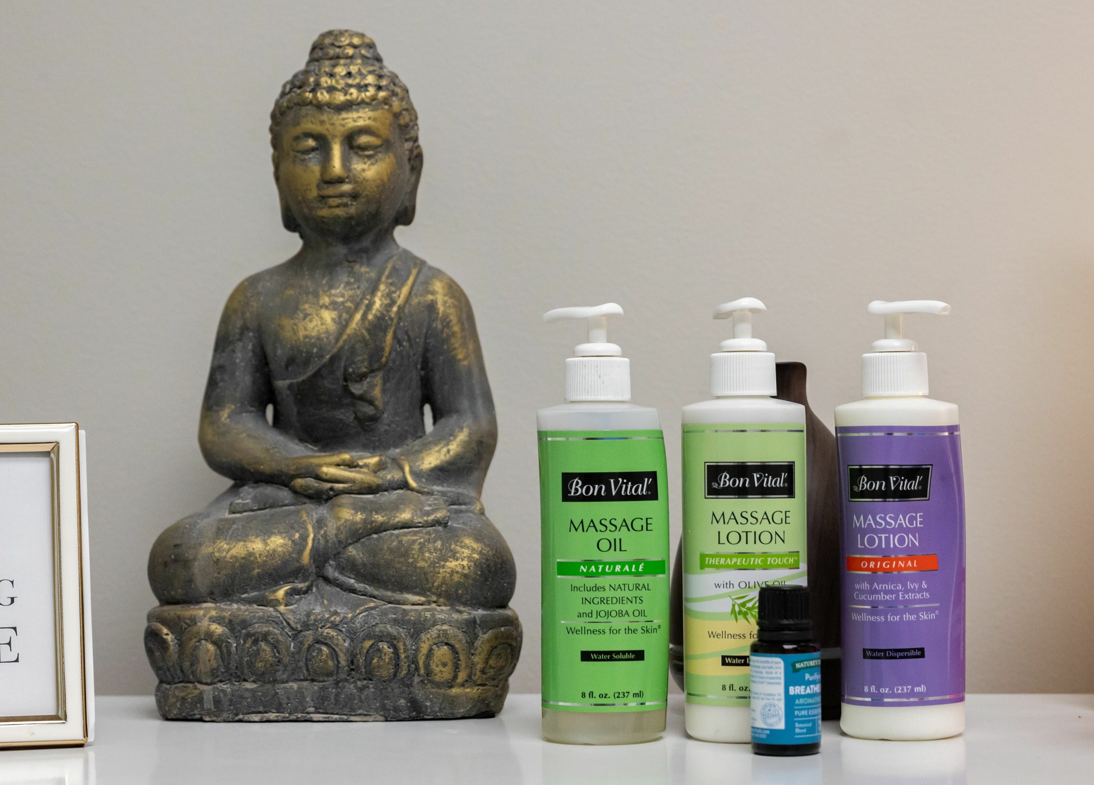 Tranquil Buddha statue and wellness oils at So Luxe Med Spa, Rancho Cucamonga, California, US.