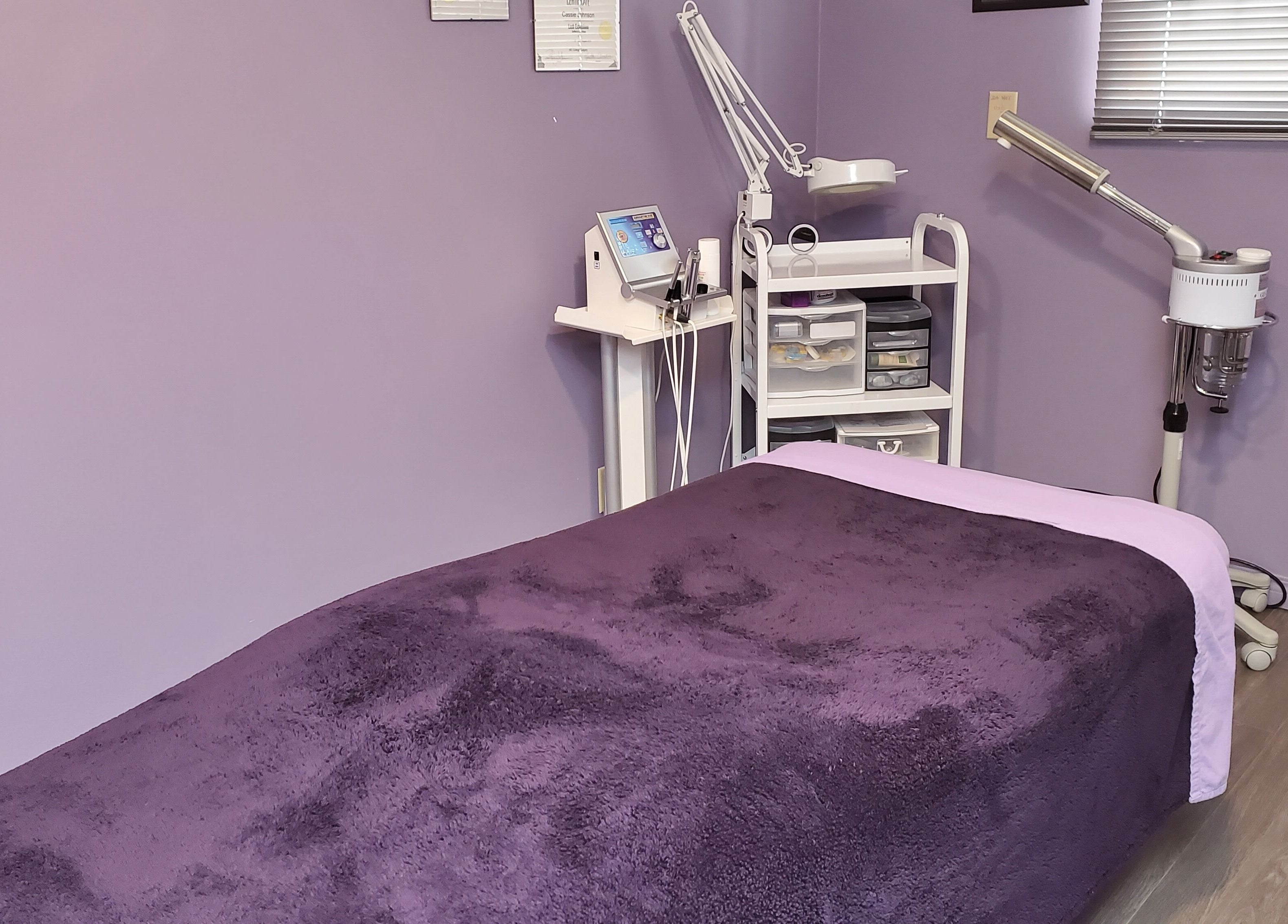 Relaxing treatment room at Stylz Salon & Spa in Strathmore, Alberta, CA with cozy massage bed.