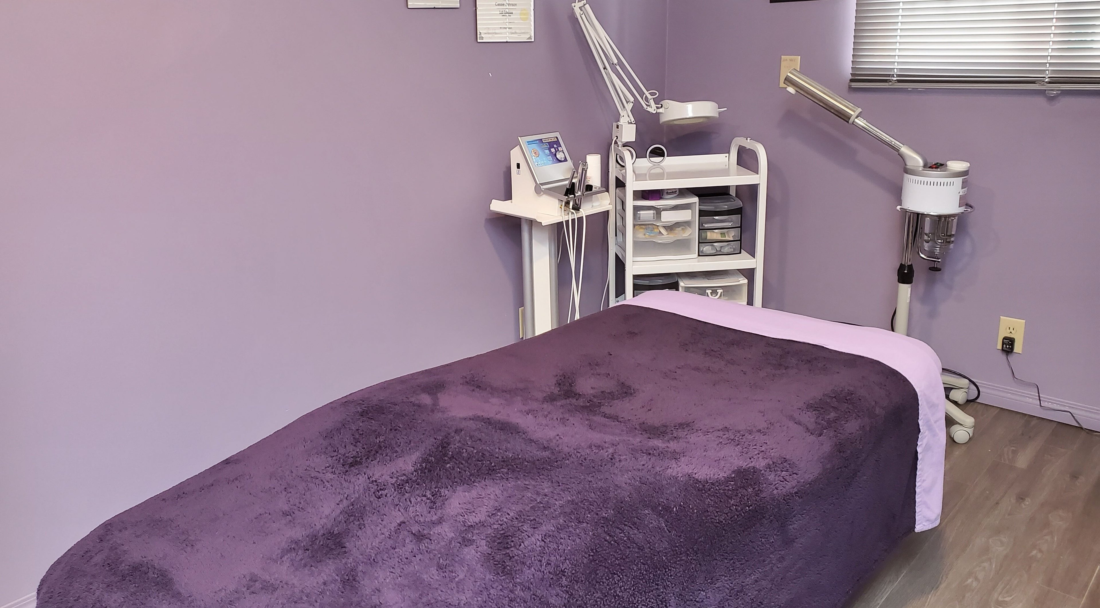 Relaxing treatment room at Stylz Salon & Spa in Strathmore, Alberta, CA with cozy massage bed.