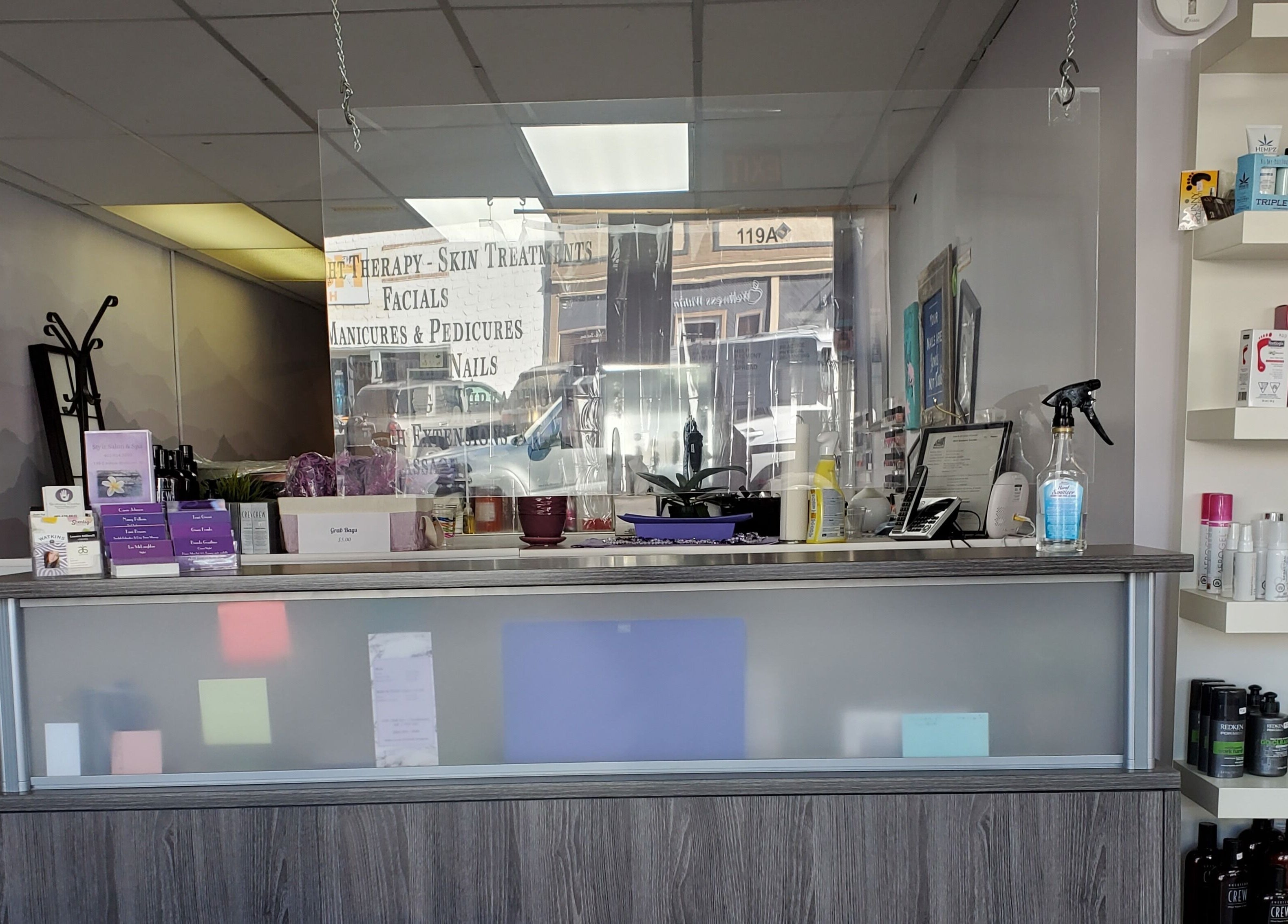 Reception area at Stylz Salon & Spa in Strathmore, Alberta, CA, showcasing beauty products and services.