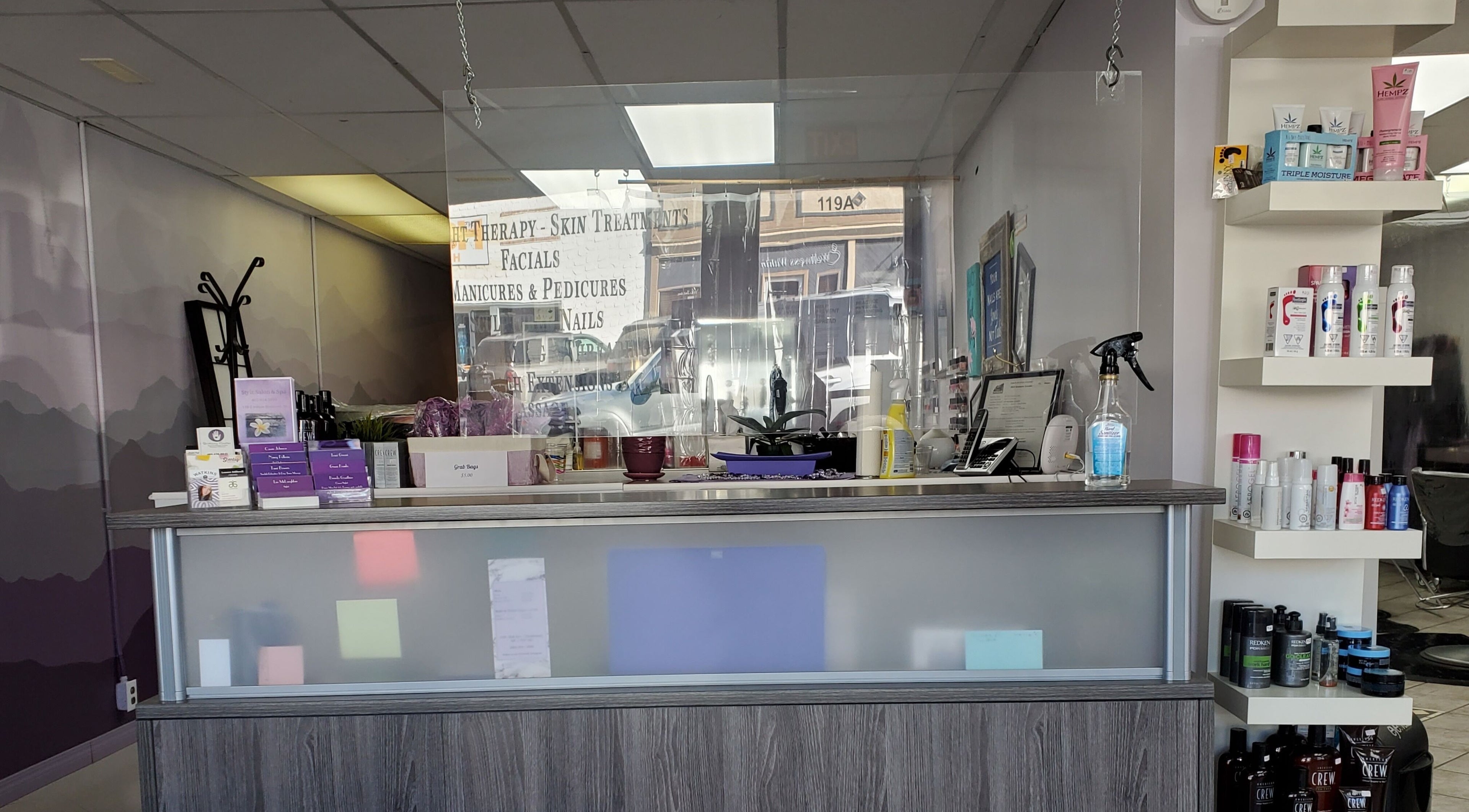 Reception area at Stylz Salon & Spa in Strathmore, Alberta, CA, showcasing beauty products and services.