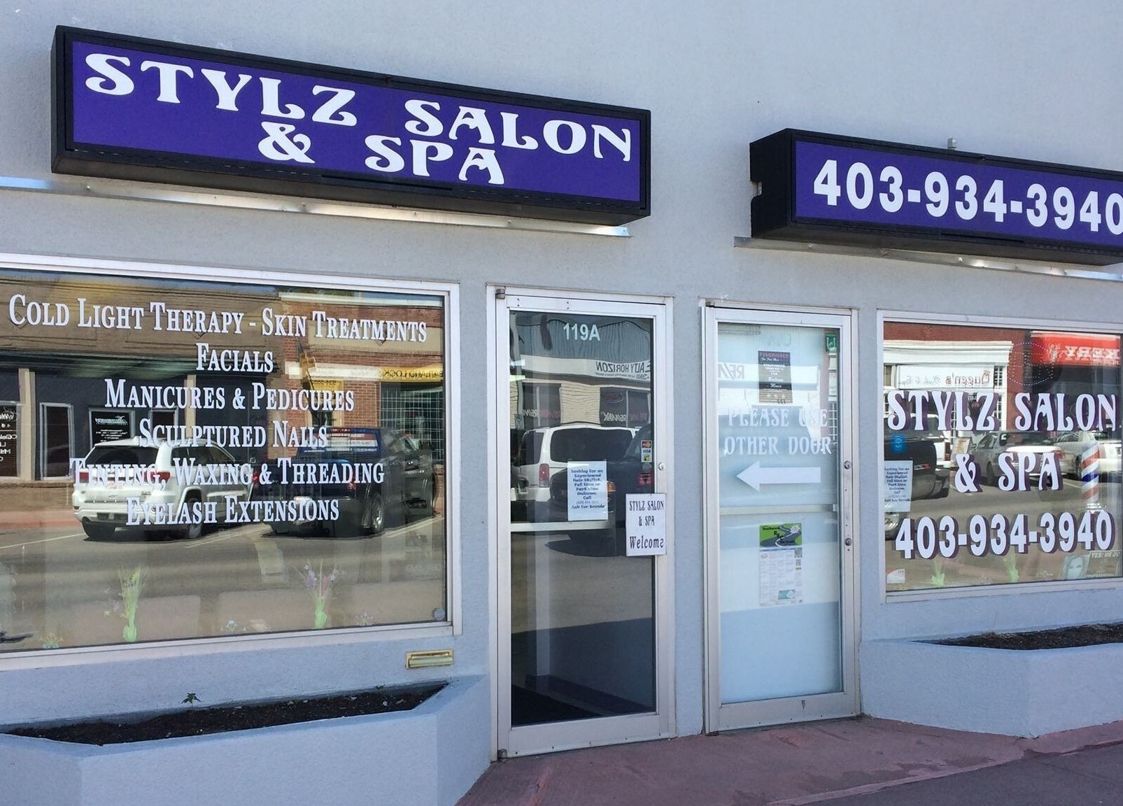 Exterior of Stylz Salon & Spa, Strathmore, Alberta, CA, featuring service listings and signage.