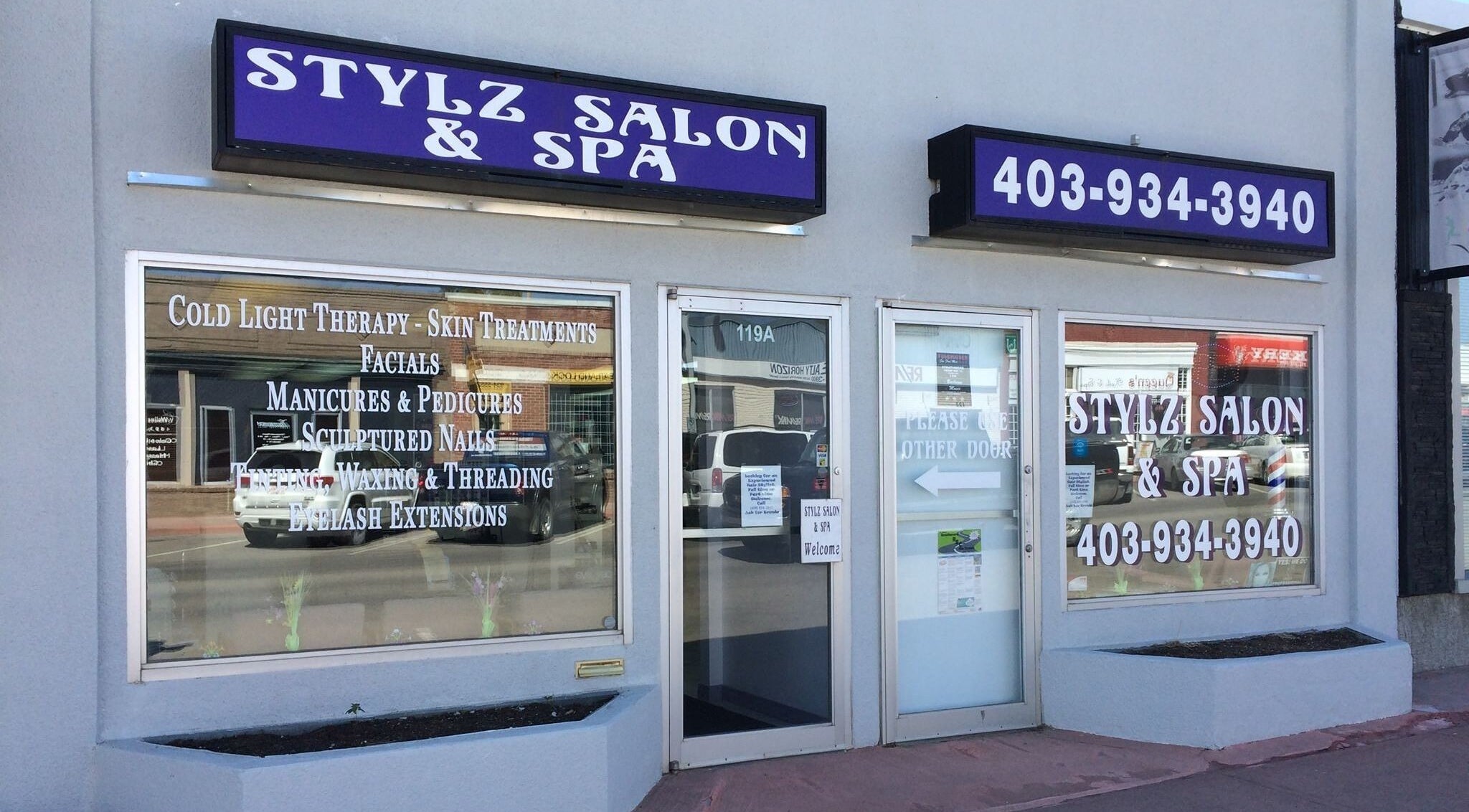 Exterior of Stylz Salon & Spa, Strathmore, Alberta, CA, featuring service listings and signage.