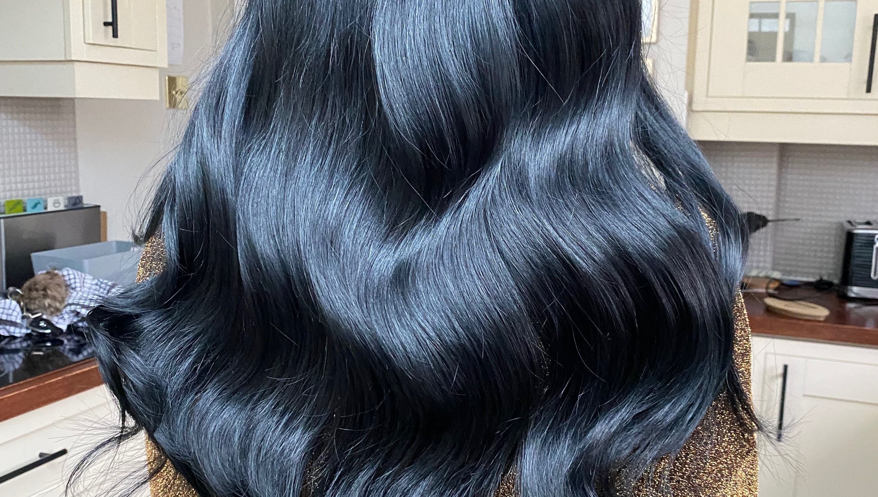 Shiny black hair styled at Hair Crown, London, England, GB.