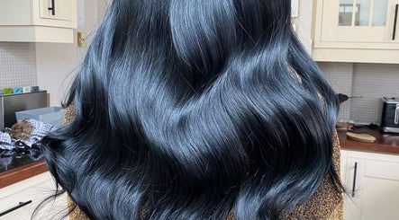 Shiny black hair styled at Hair Crown, London, England, GB.