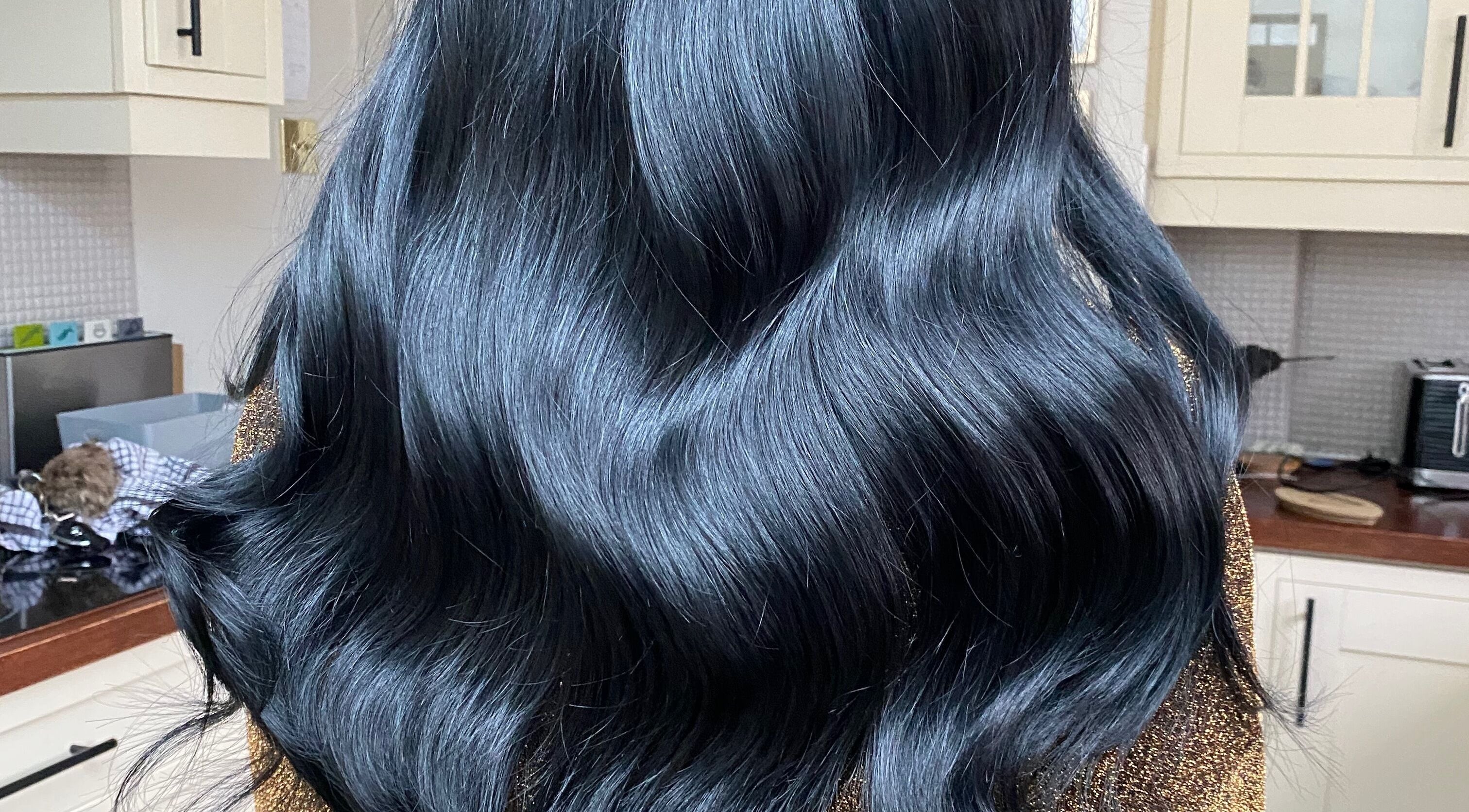 Shiny black hair styled at Hair Crown, London, England, GB.