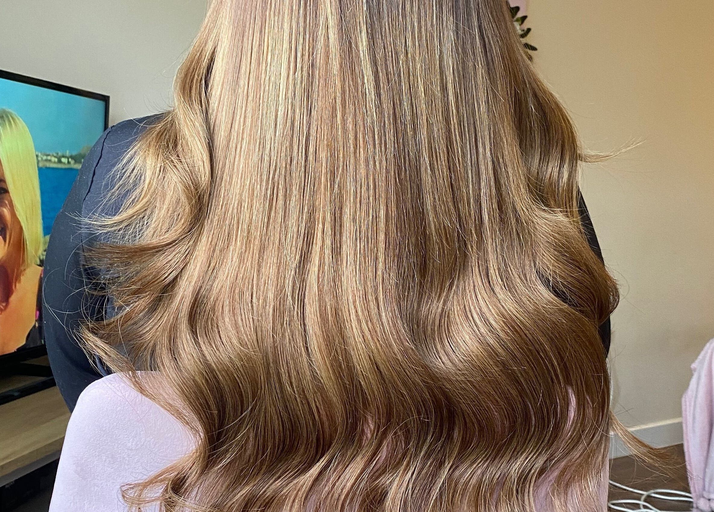 Glowing, wavy blonde hair styled at Hair Crown, London, England, GB.