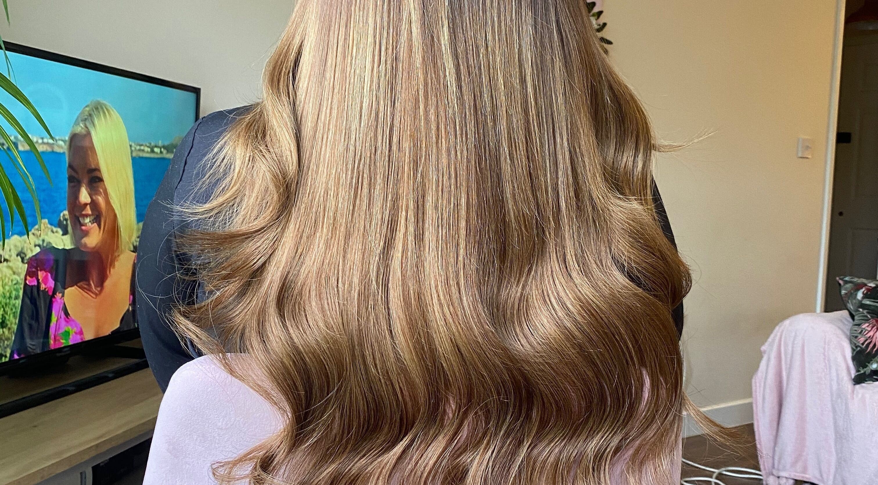 Glowing, wavy blonde hair styled at Hair Crown, London, England, GB.